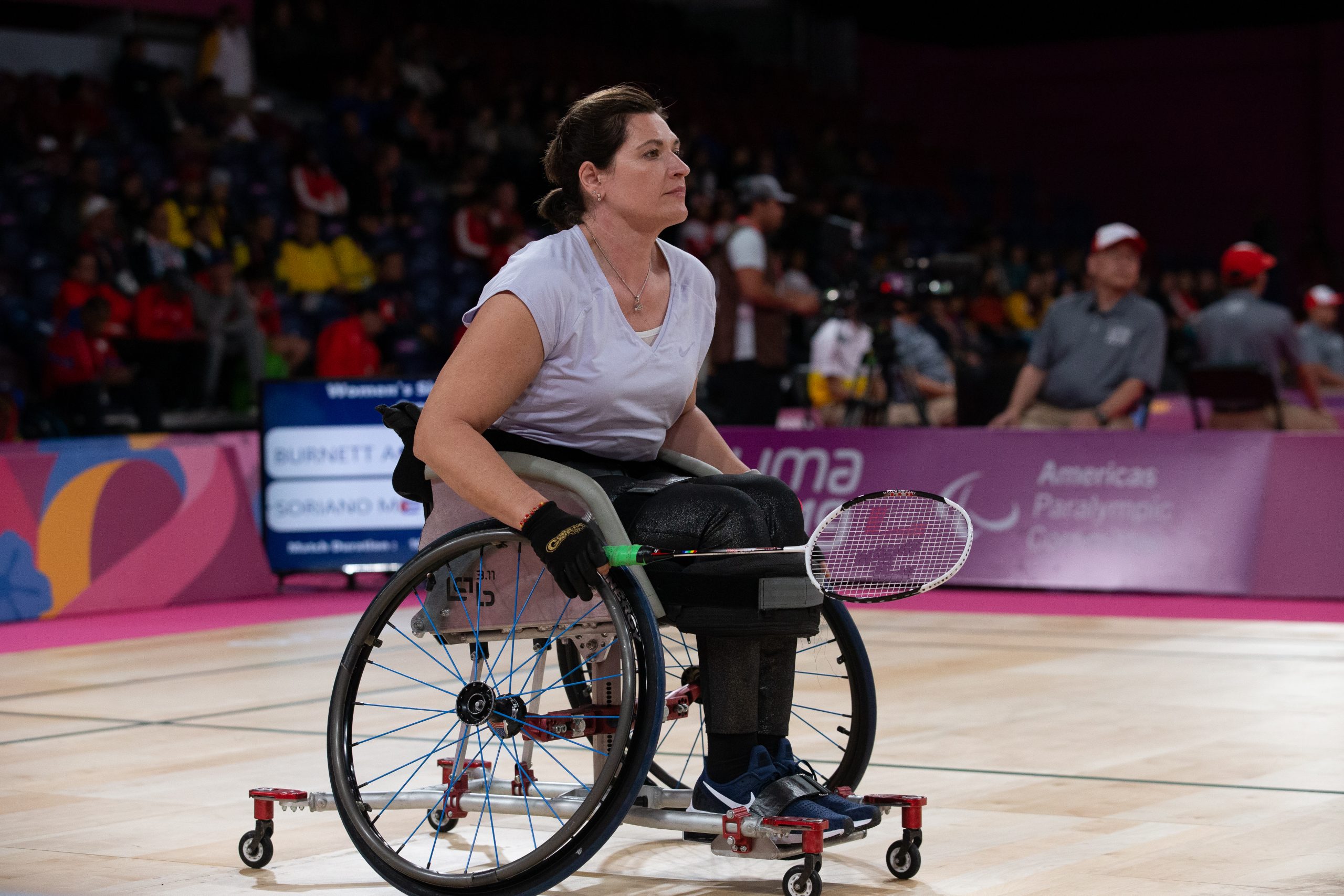 Female athlete in wheelchair holding a badminton racket