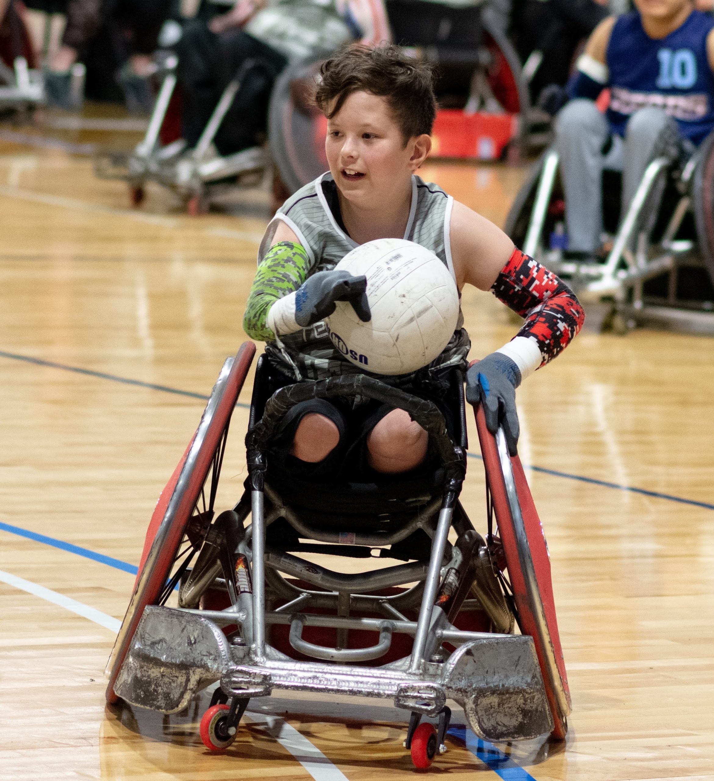 Male athlete in a wheelchair holding a volleyball