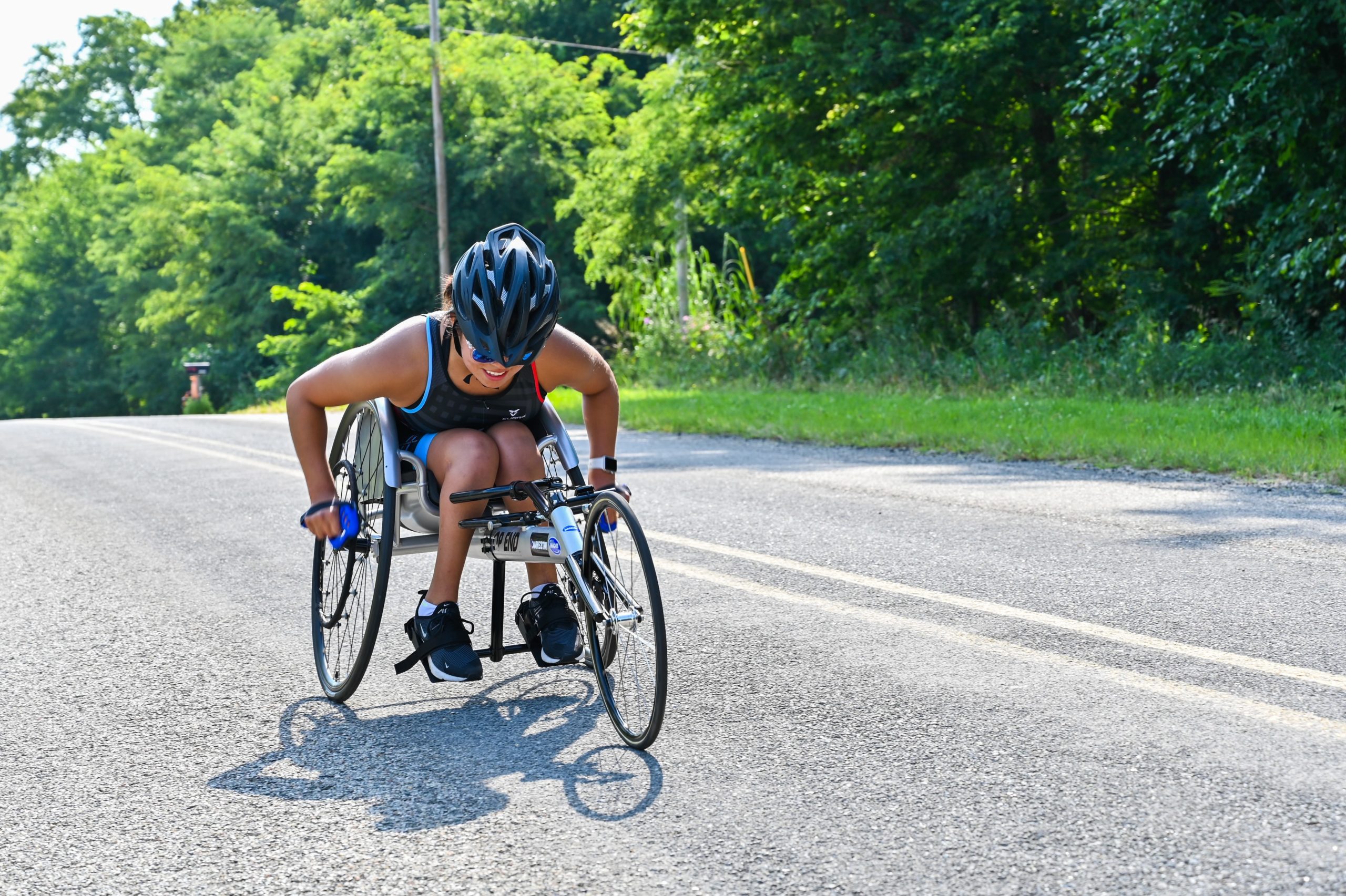 Athlete on road using a racing wheelchair
