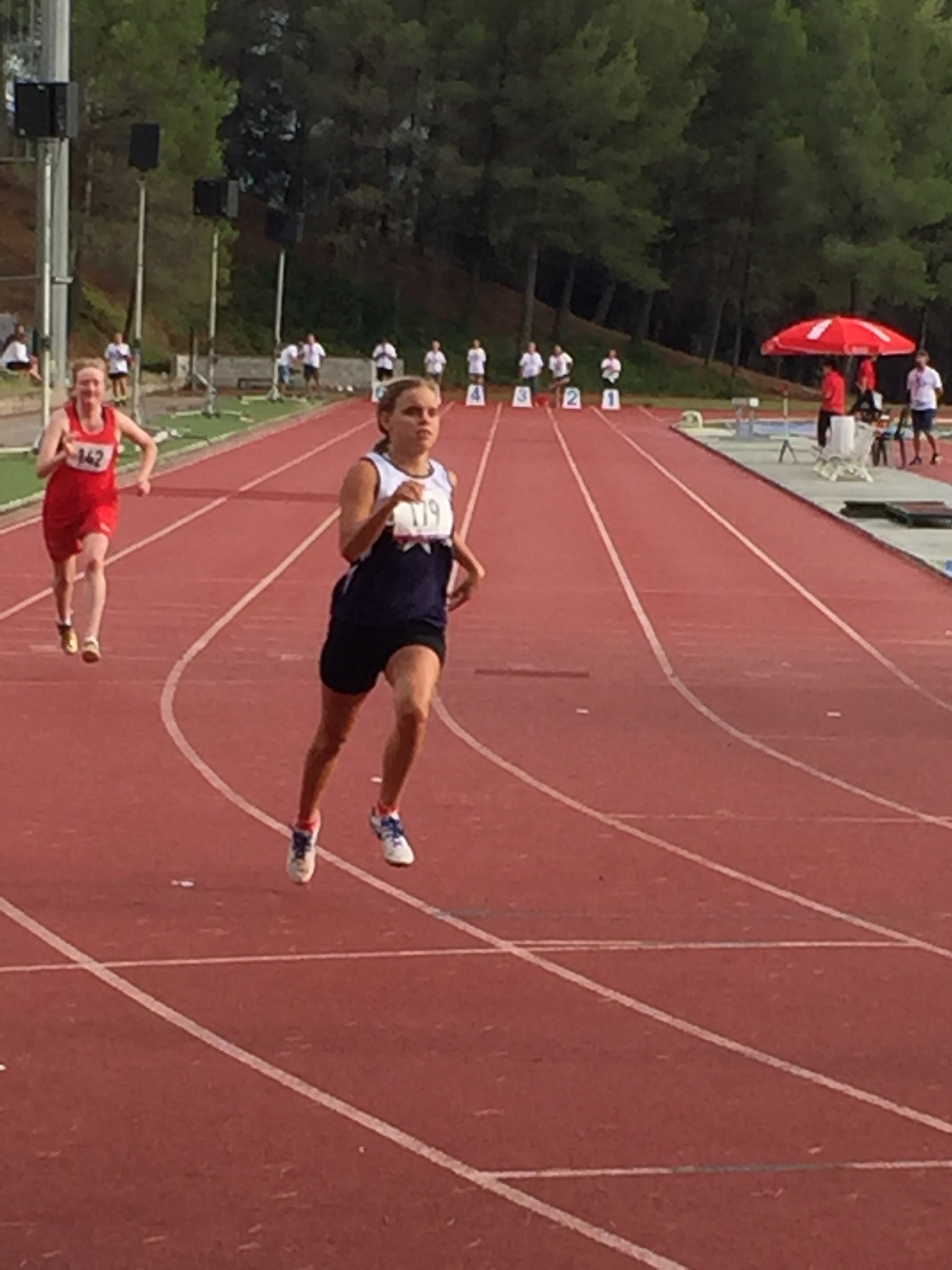 Female athlete running on a track