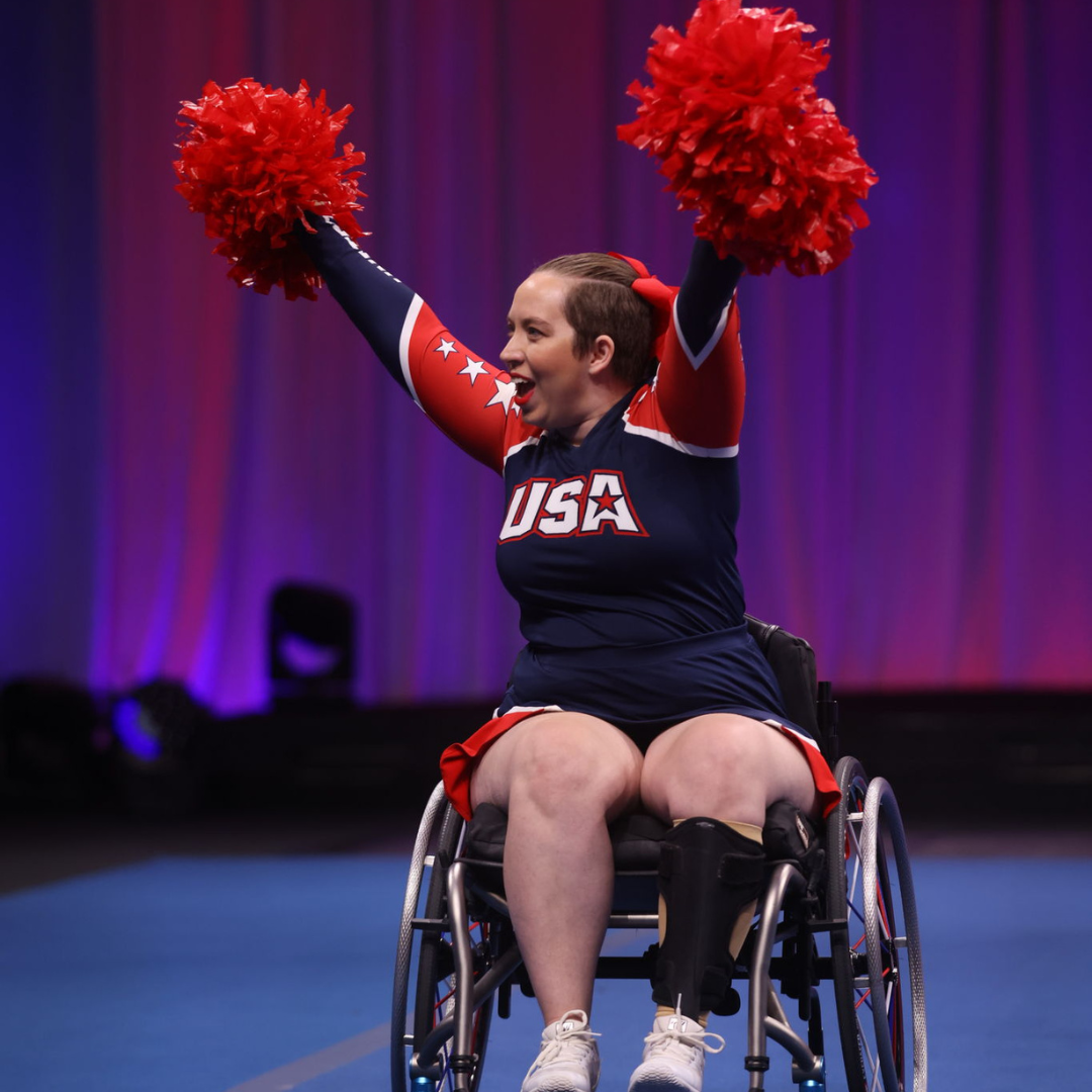 person in a wheelchair participating in cheerleading