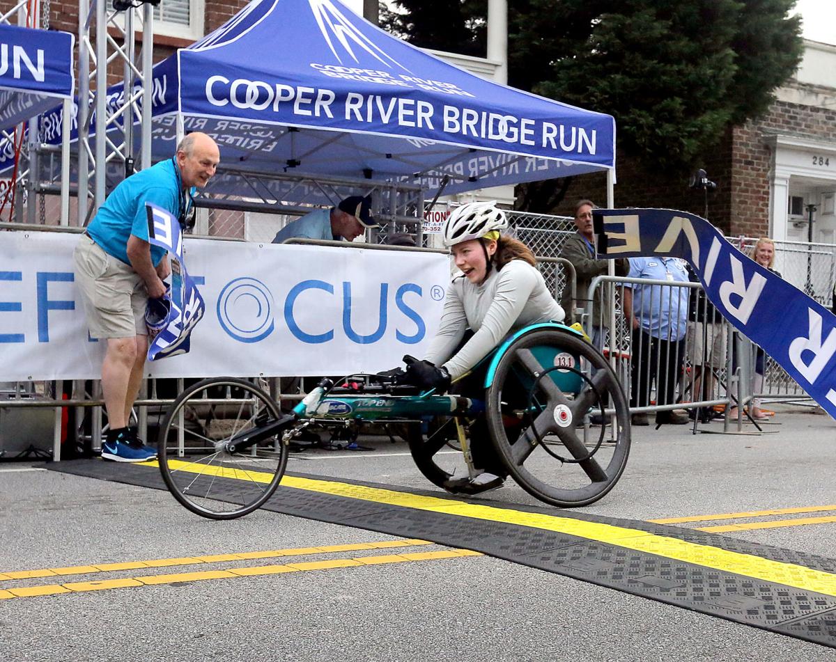 Athlete in racing wheelchair crossing yellow line in competition