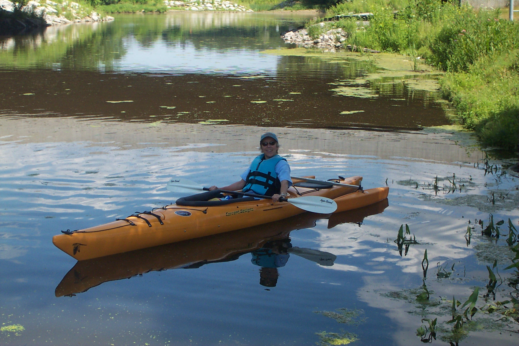 Woman sitting in a canoe smiling at the camera