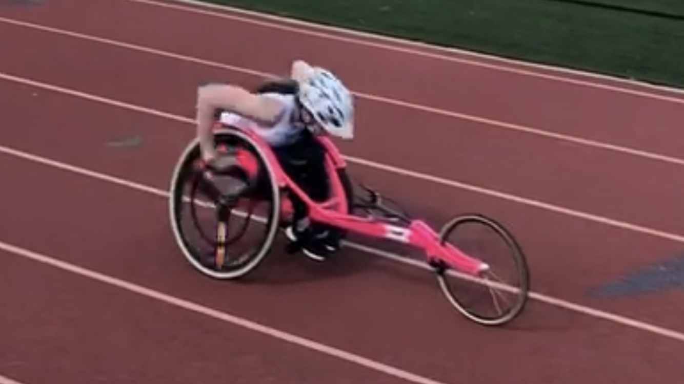 Athlete in racing wheelchair on track