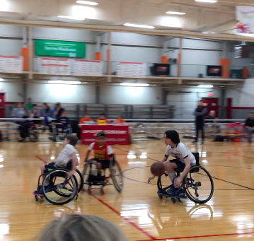 Athletes playing wheelchair basketball