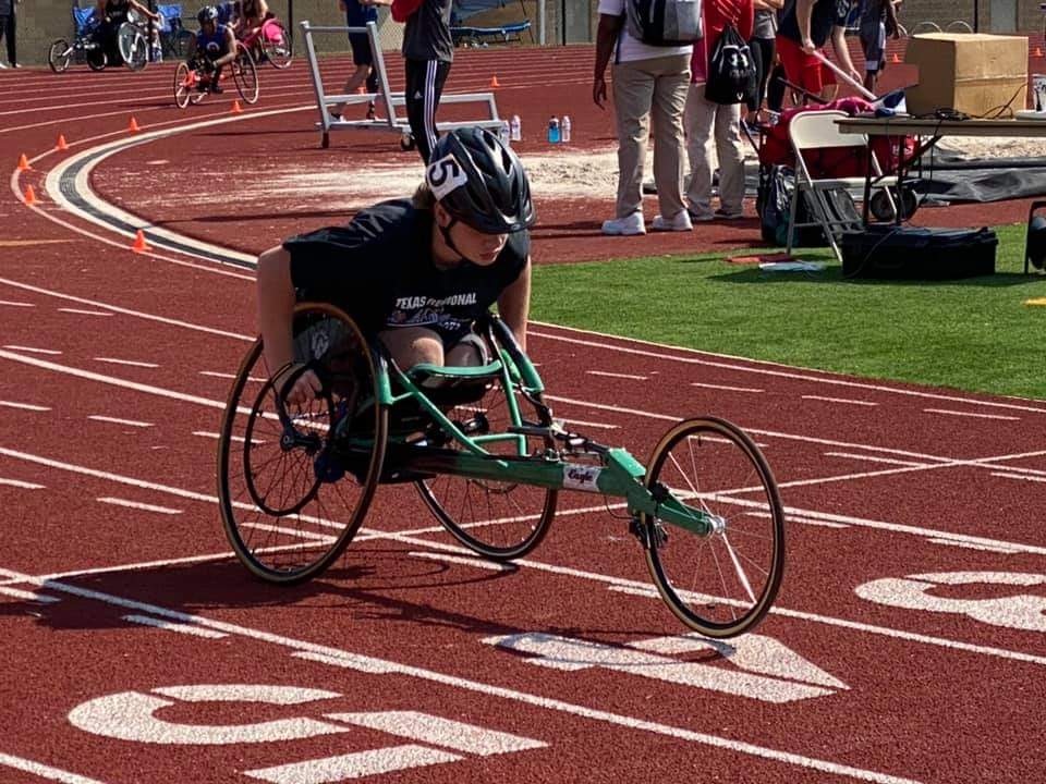 Athlete in a racing wheelchair on a track