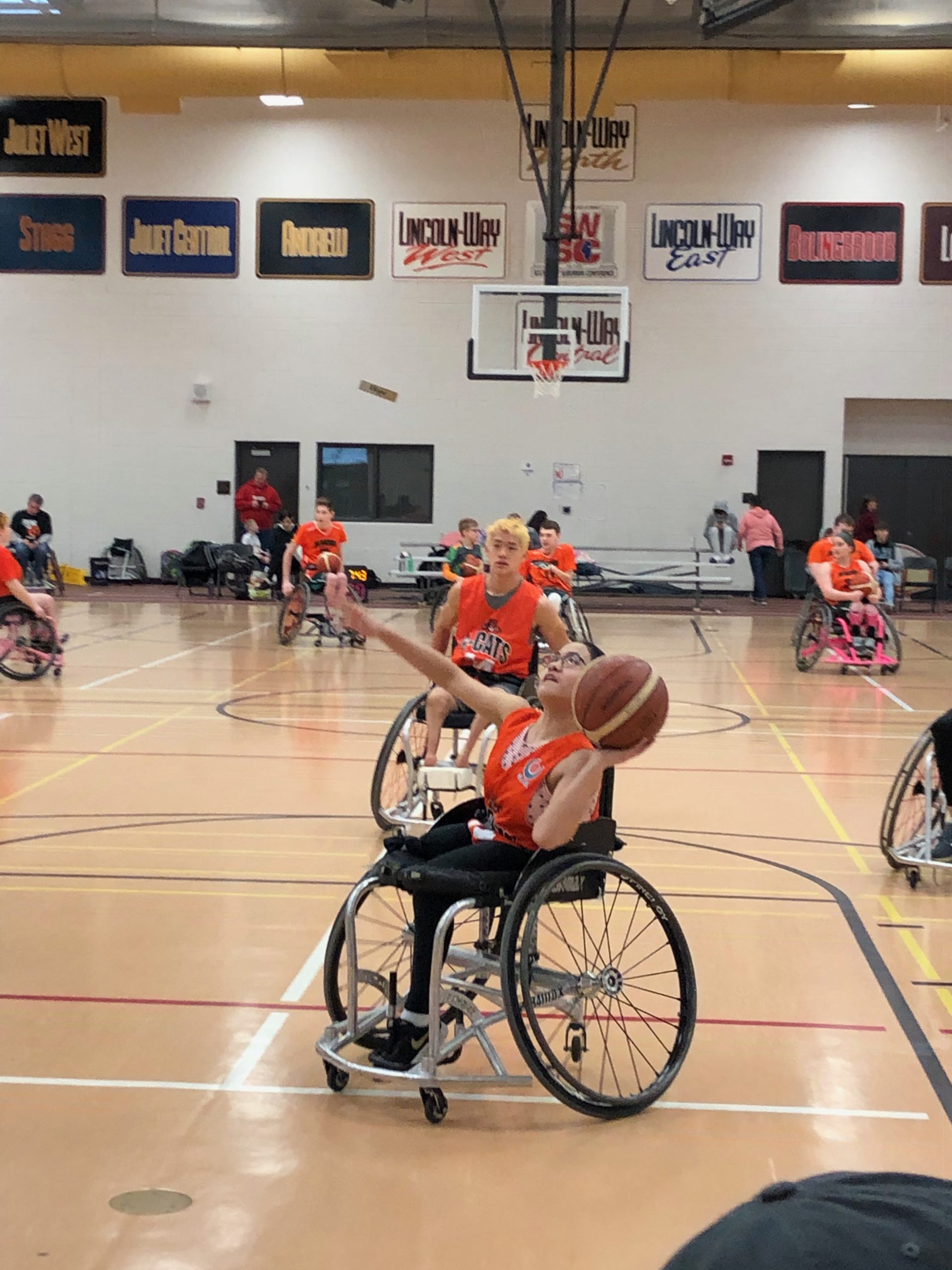 Group of athletes playing wheelchair basketball