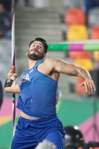 Adaptive male athlete throwing the javelin
