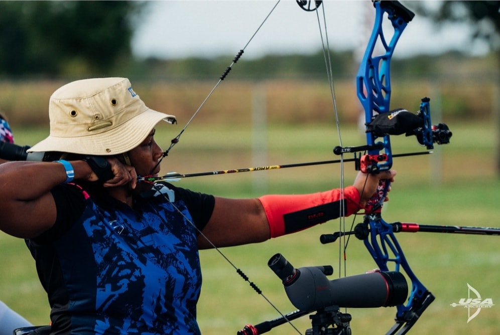 Female athlete aiming a bow and arrow