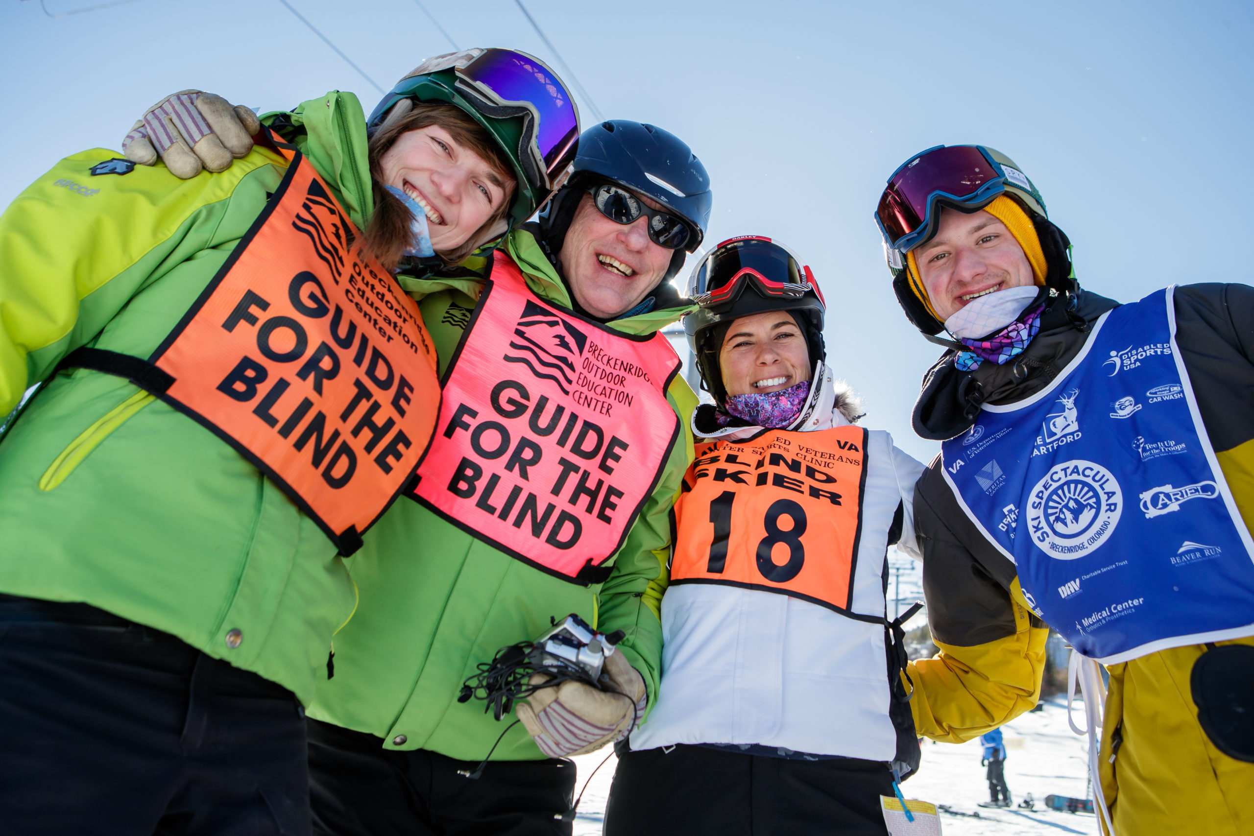 Group of athletes in snow clothing smiling towards the camera