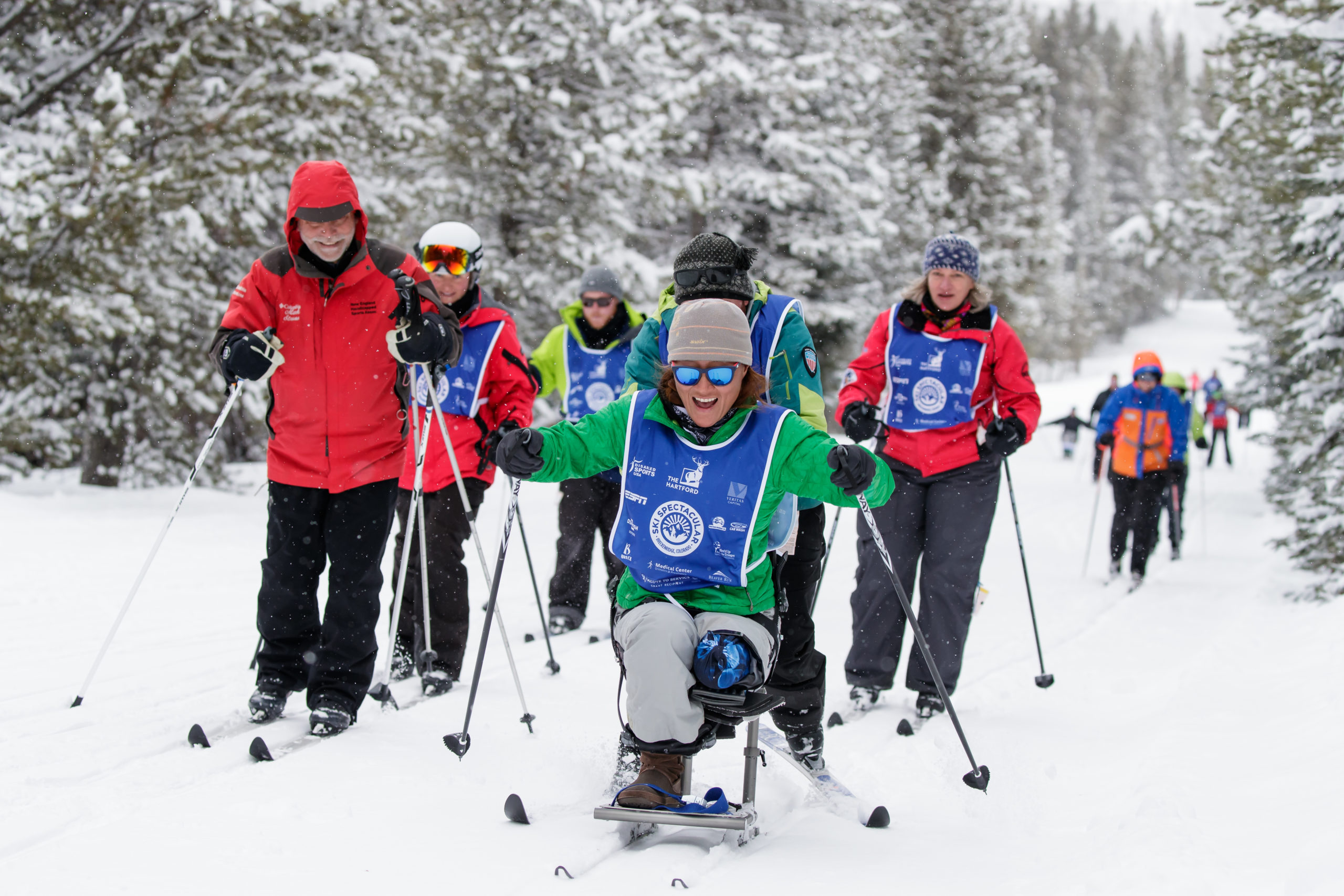 Ski Spec athletes and coaches on skis and bi-skis on ski slope