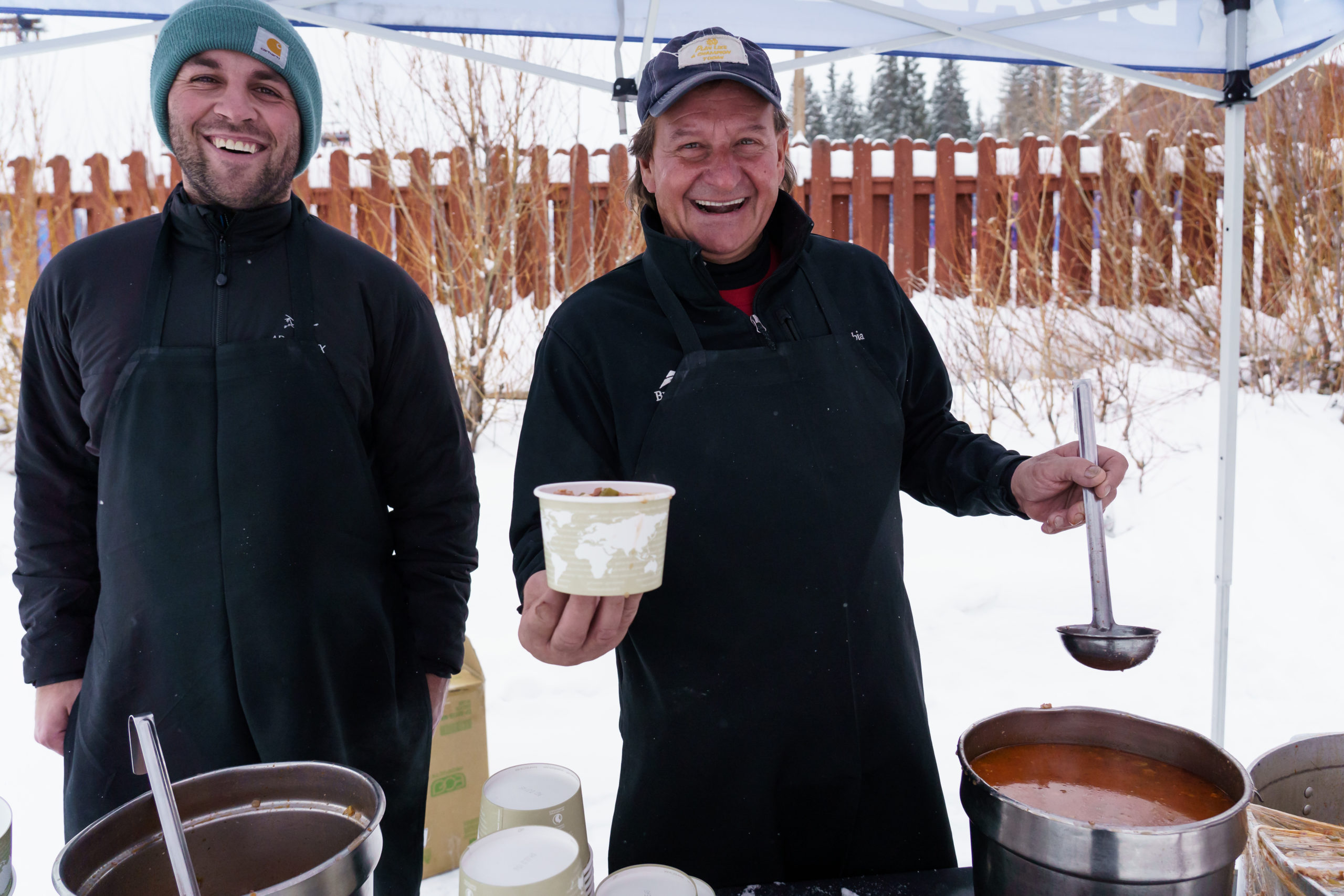 Ski Spec volunteers smiling and serving soup