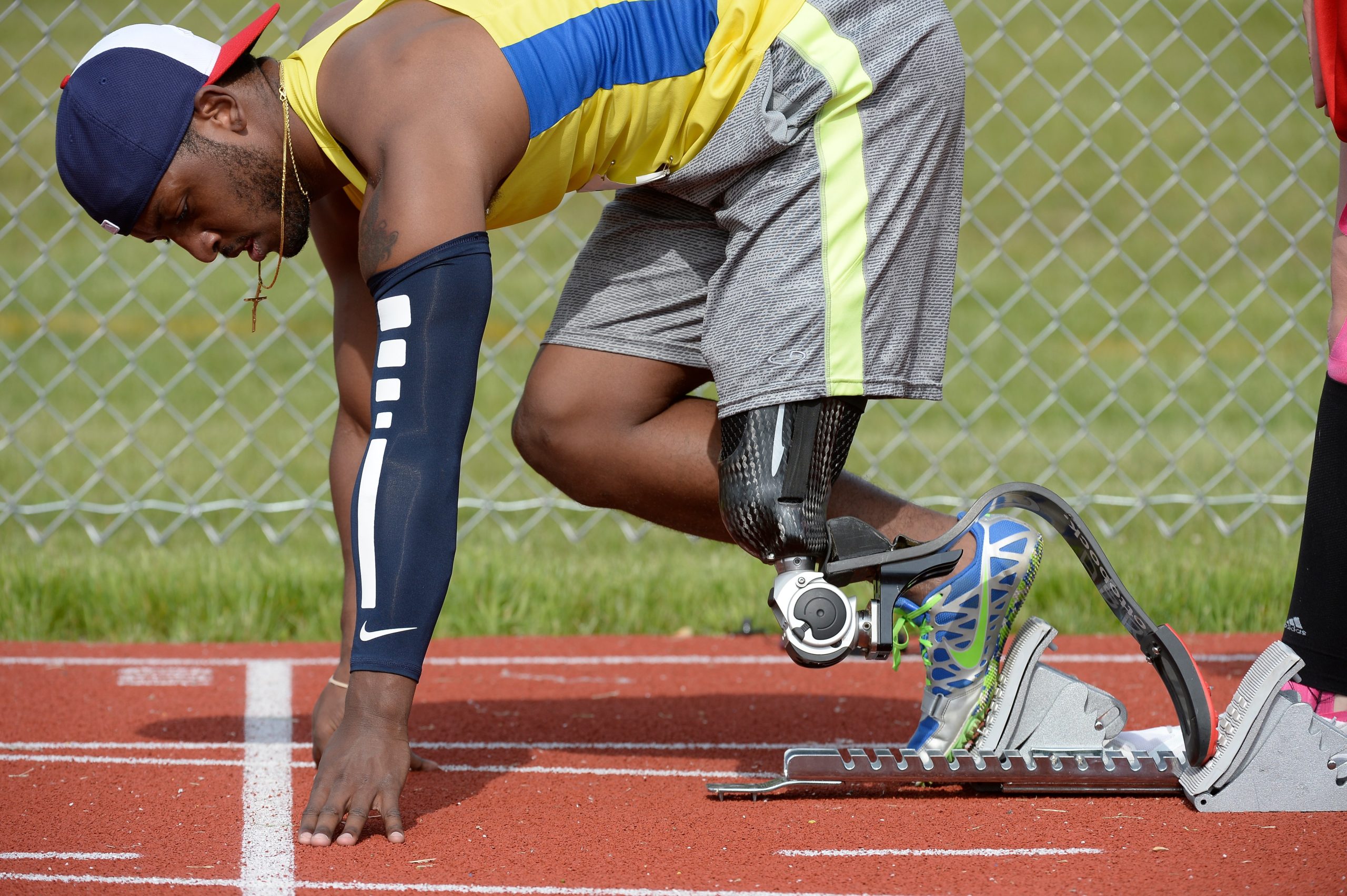 Male athlete pushing off of starting block with left leg prosthetic