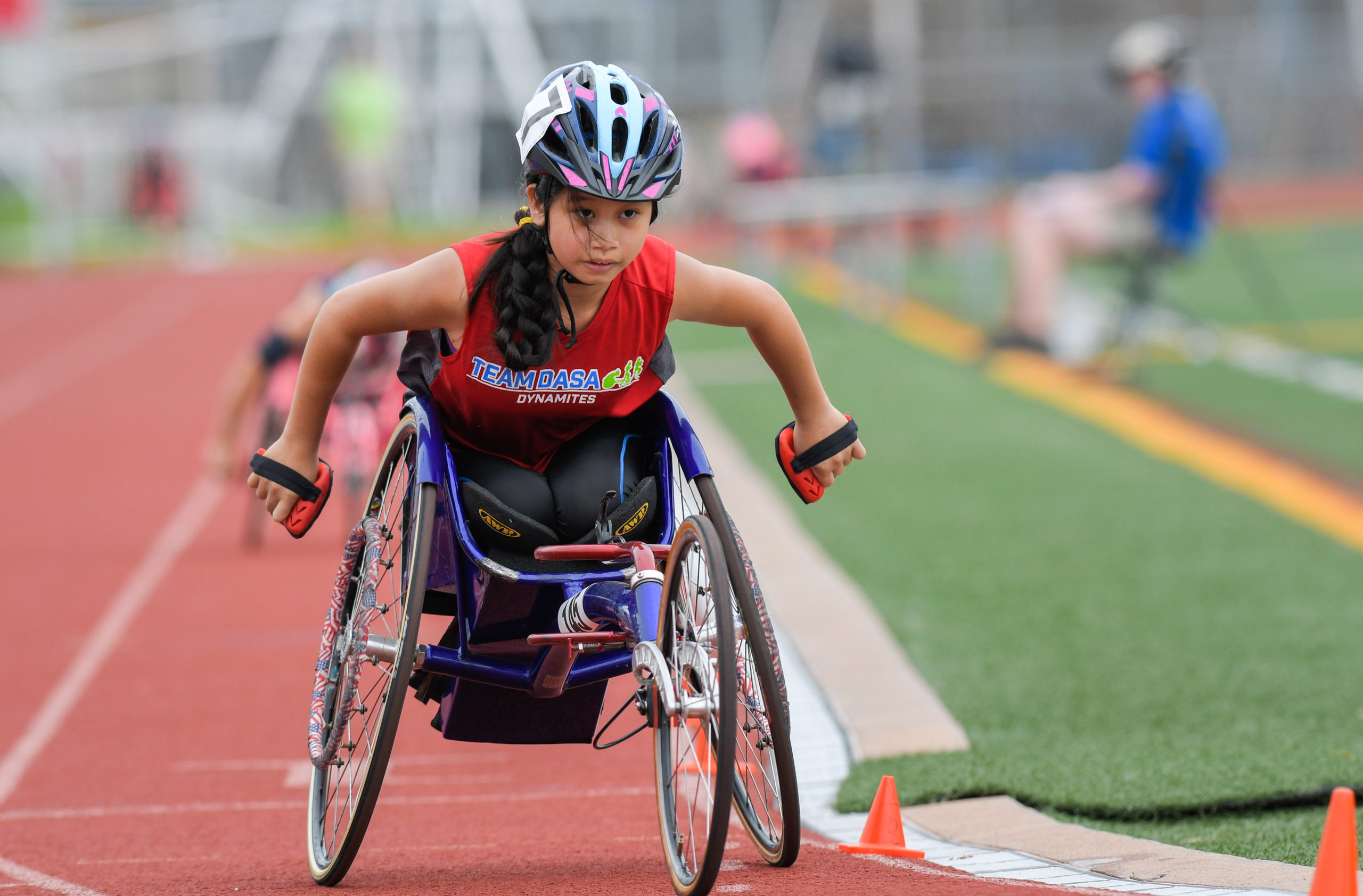 Female athlete competing in racing wheelchair