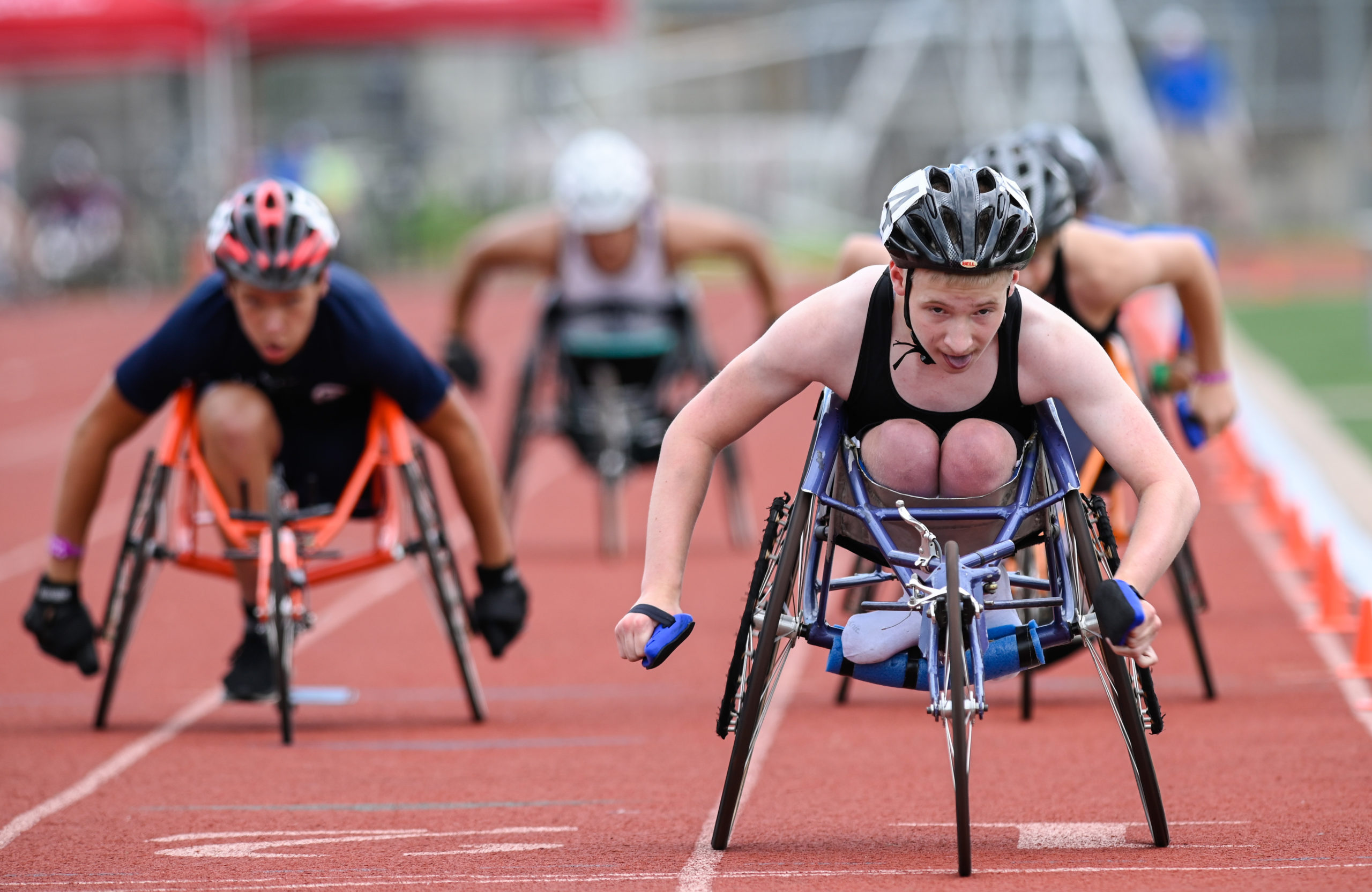 Athletes competing in a race using racing wheelchairs