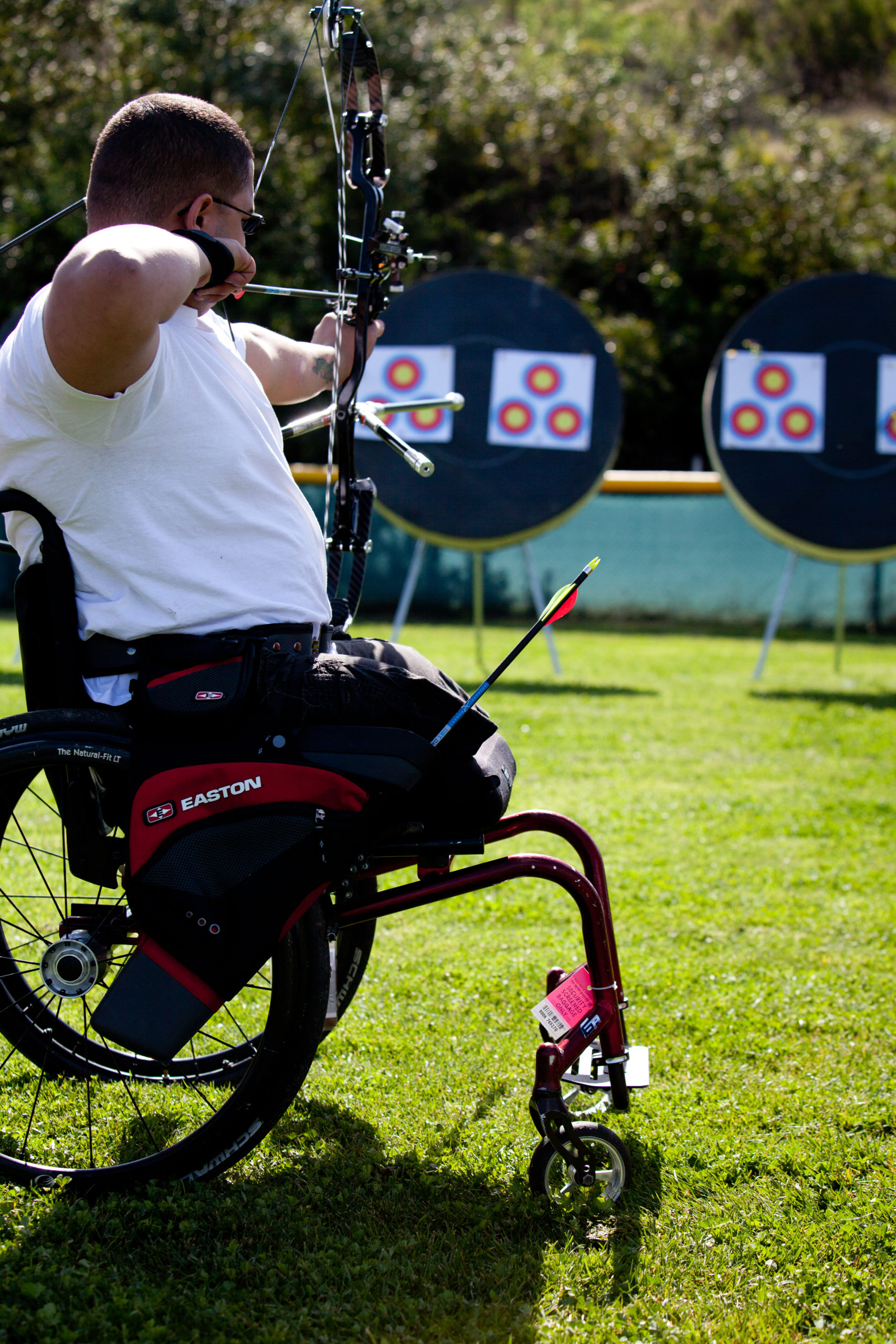 male athlete using wheelchair and doing archery