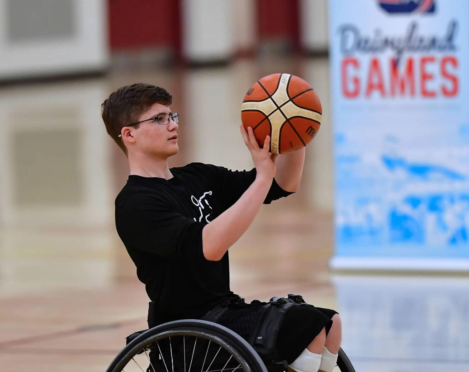Wheelchair athlete shooting basketball