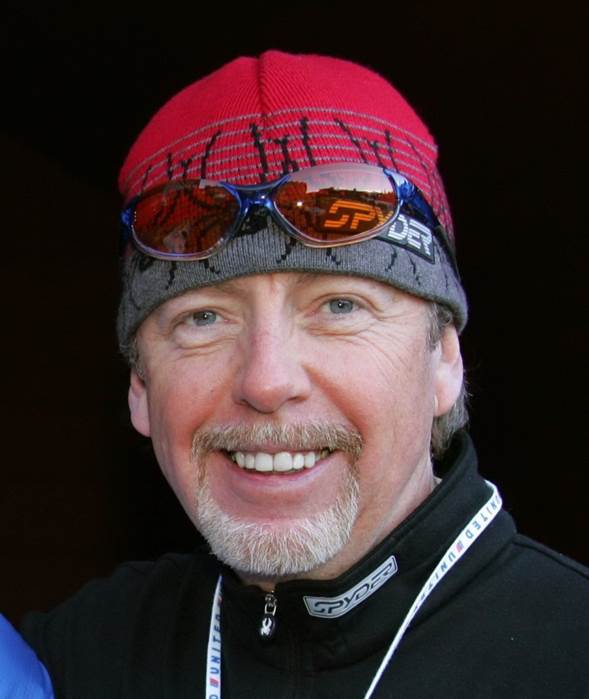 Man with ski hat and glasses smiling at the camera