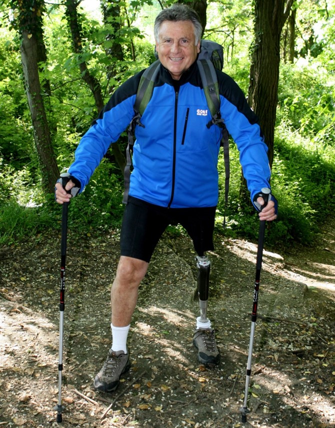 Male athlete with left leg prosthetic hiking posed for a picture and smiling at the camera