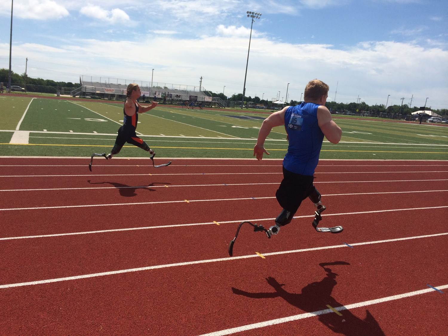 Two athletes with double leg prosthetics running