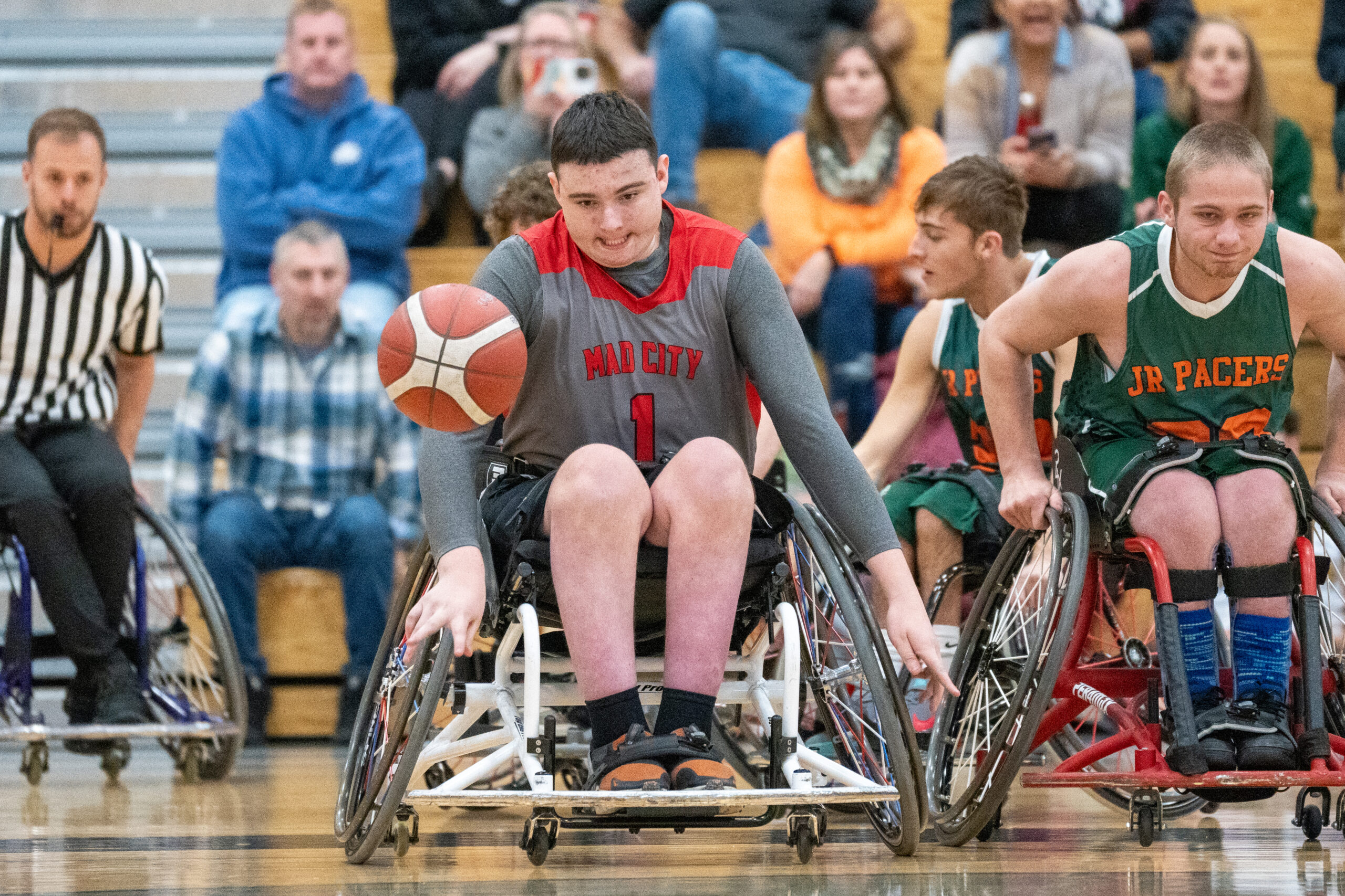 Wheelchair Basketball athlete dribbling the ball
