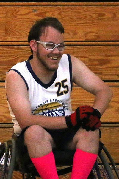 Athlete sitting in wheelchair smiling at camera