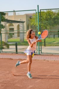Young female athlete playing tennis