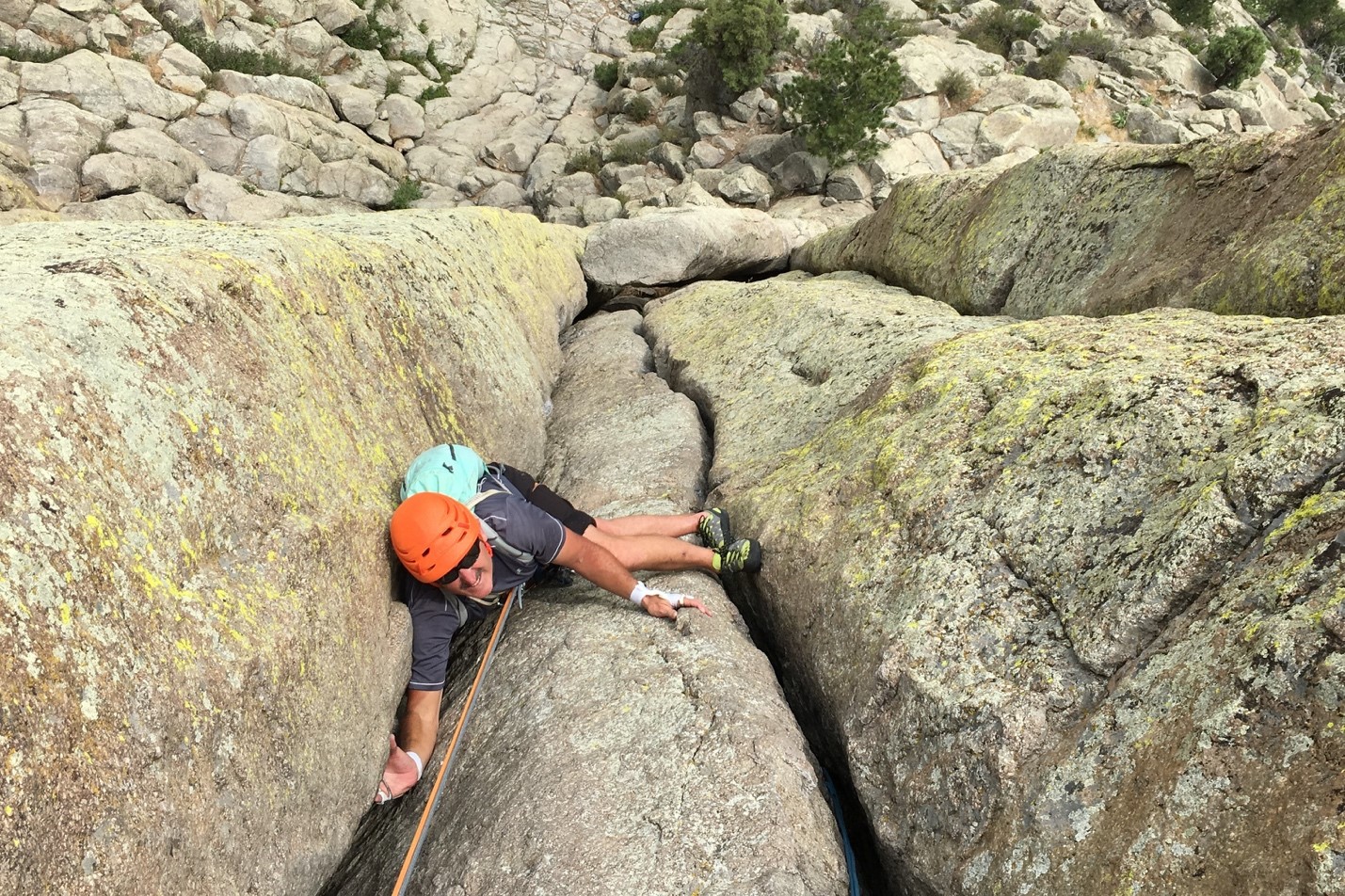 Athlete climbing up a rock.