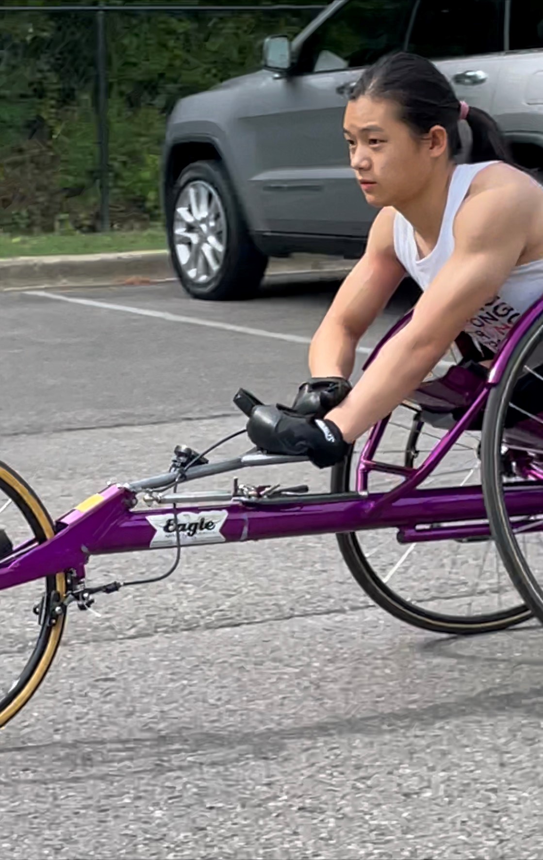 Athlete participating in wheelchair race.