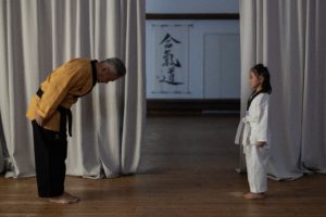 karate instructor bowing to student