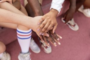 athletes in a hand huddle