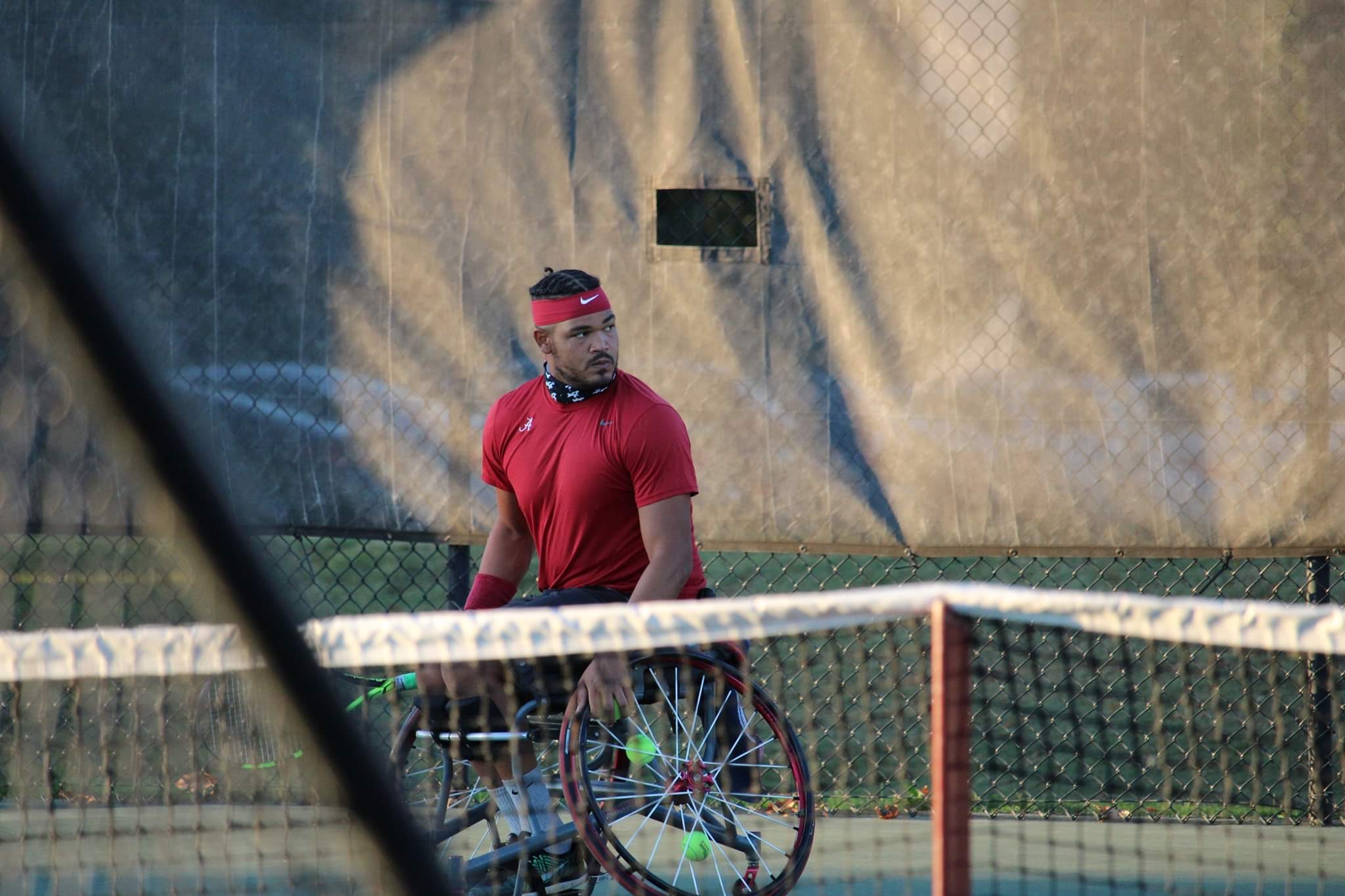 Jeremy Boyd playing wheelchair tennis on a court