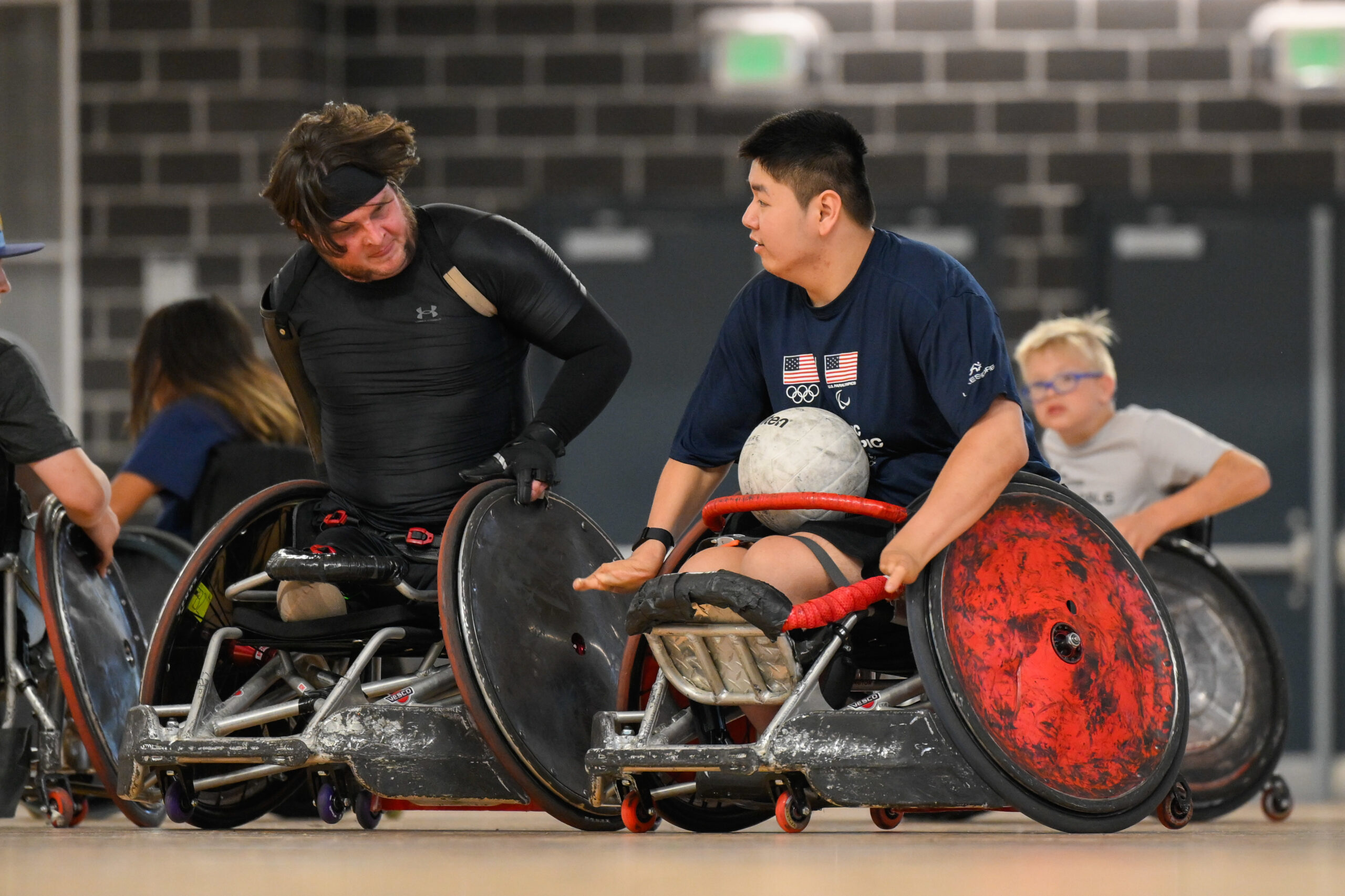 Tim Brown, in black, defends against Zion Redington durinng a wheelchair rugby clinic at The Hartford Nationals.