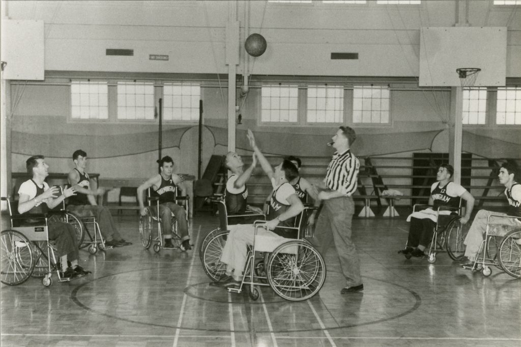 old photo of two early wheelchair basketball teams playing the game