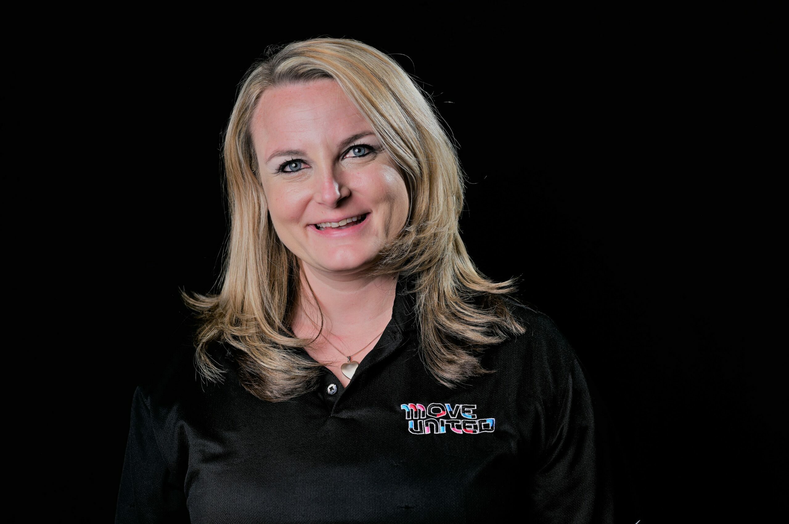 Headshot of a staff member with a black background