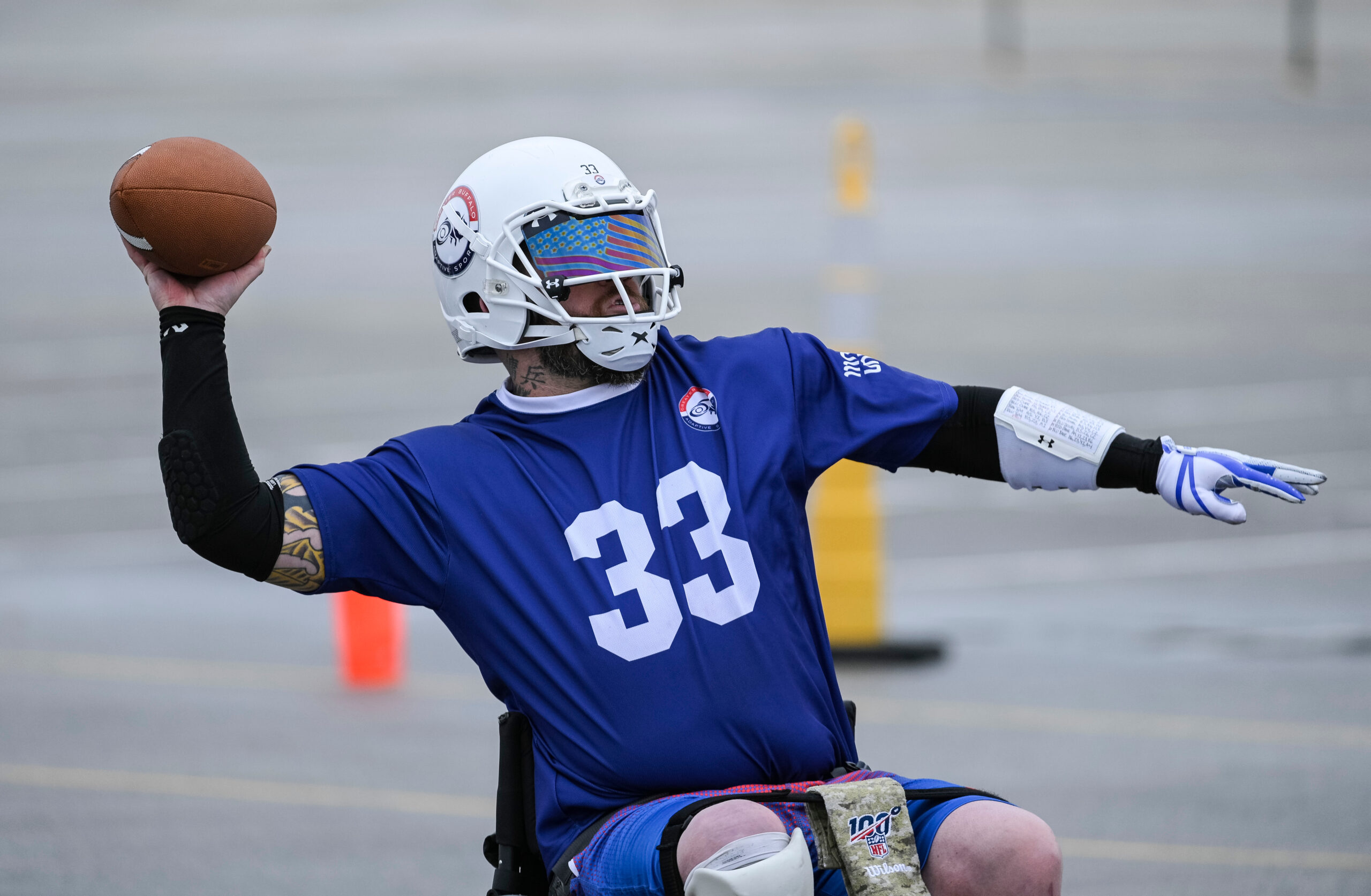 A person in wheelchair throwing a football
