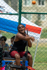 young black athlete competing in a seated field competition
