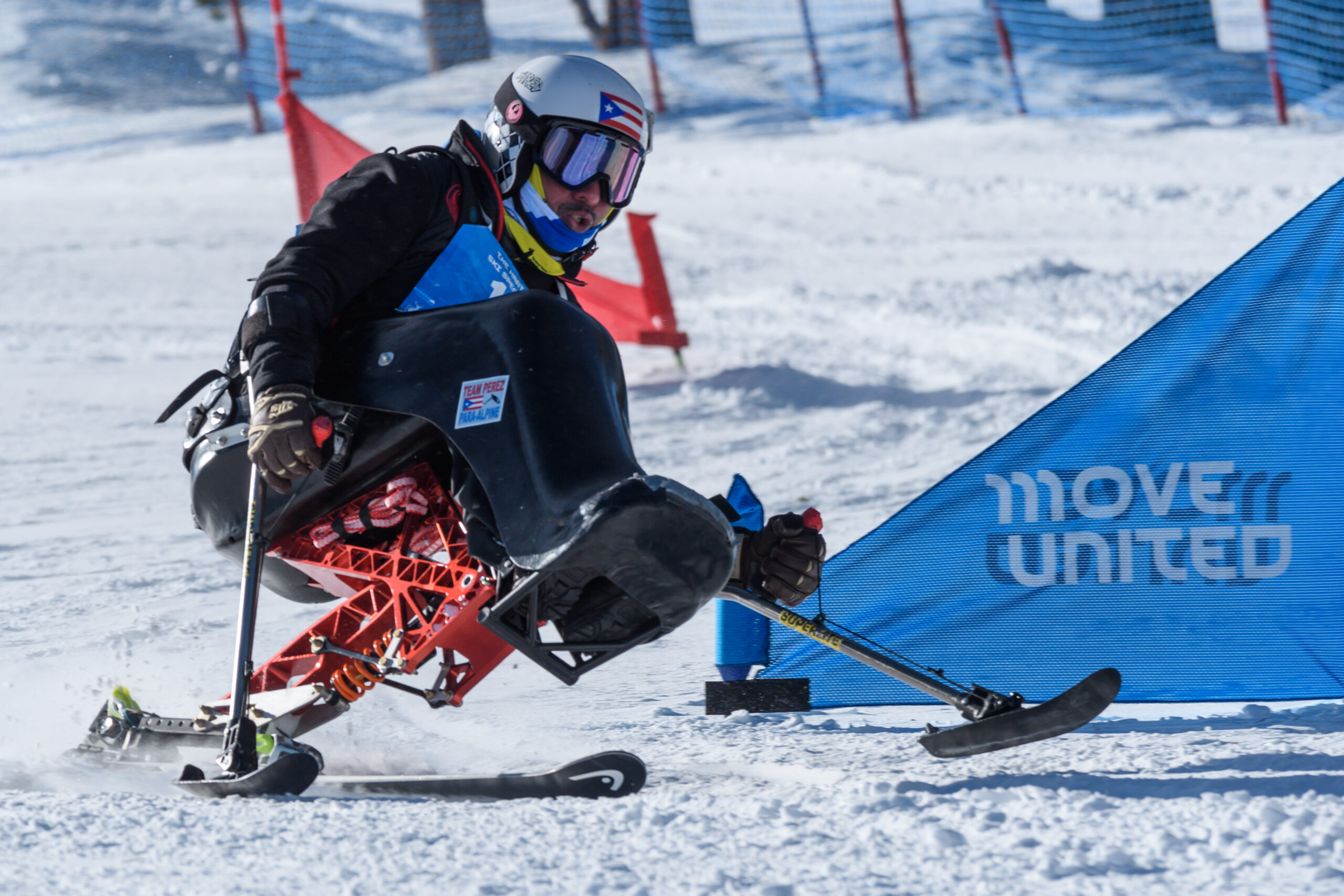 An adaptive skier going down a ski slope