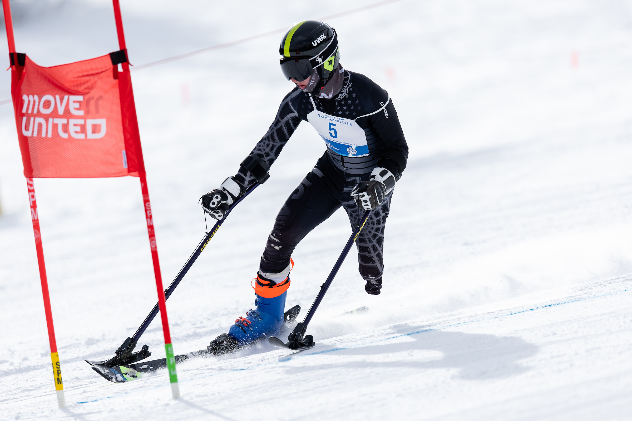 An adaptive skier going down a ski slope