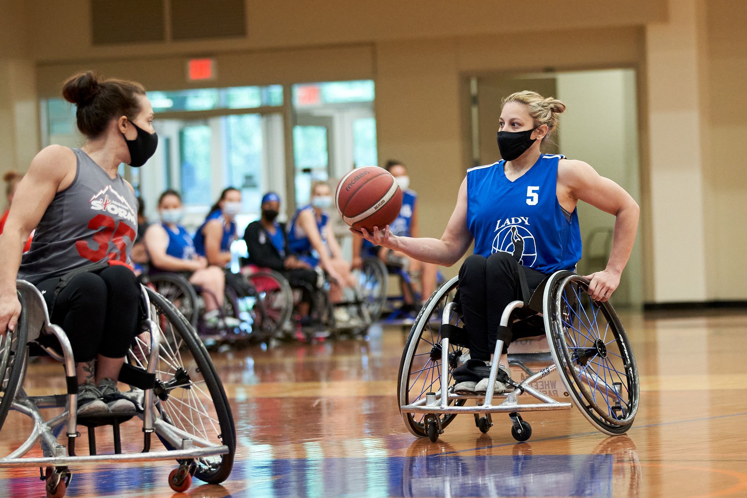 Darlene Hunter playing wheelchair basketball against an opponent