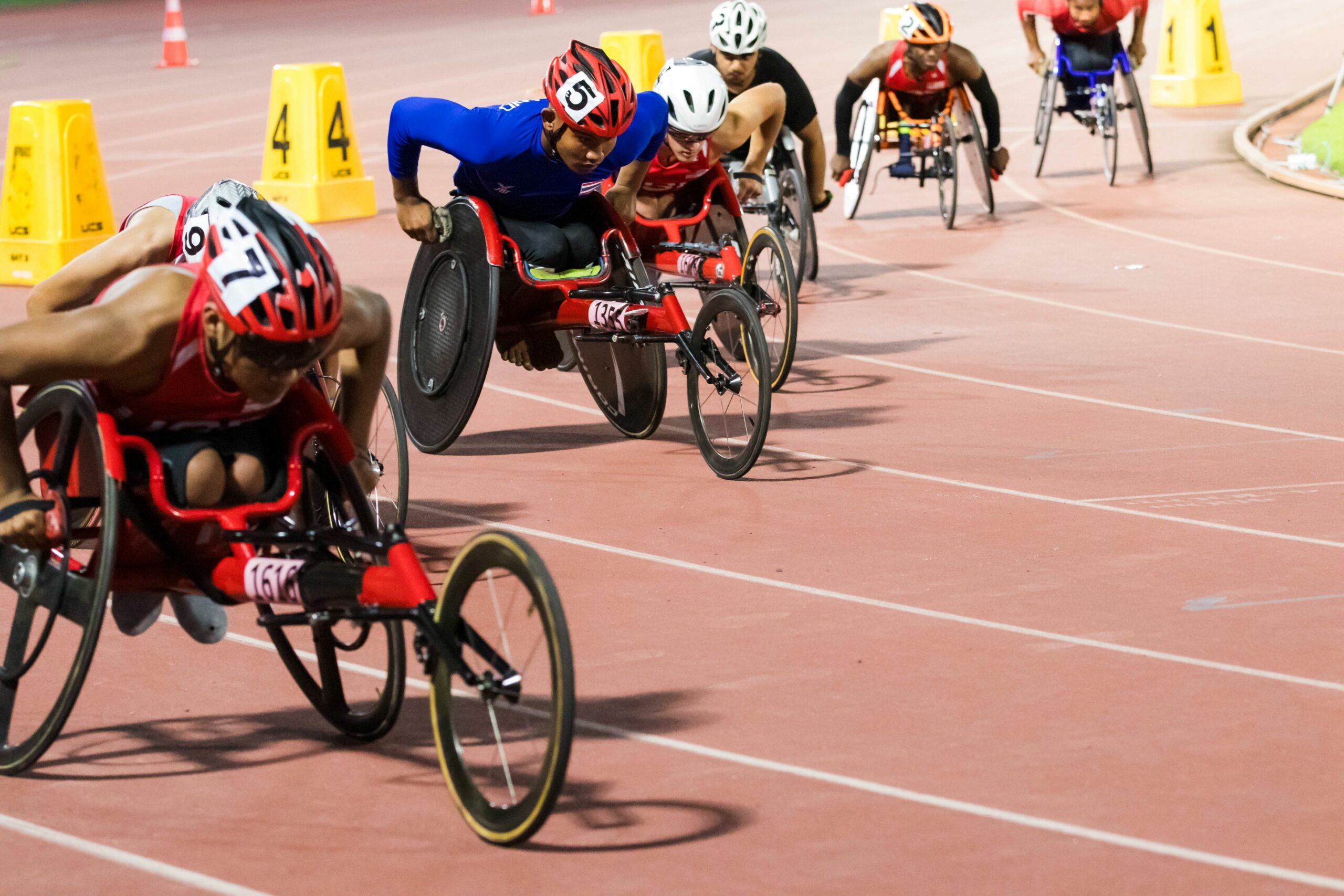 Wheelchair athletes lined up on a track getting ready to race