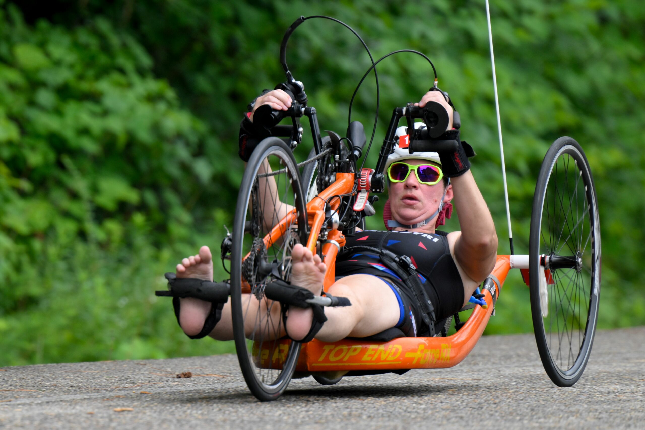 Athlete competing on orange handcycle