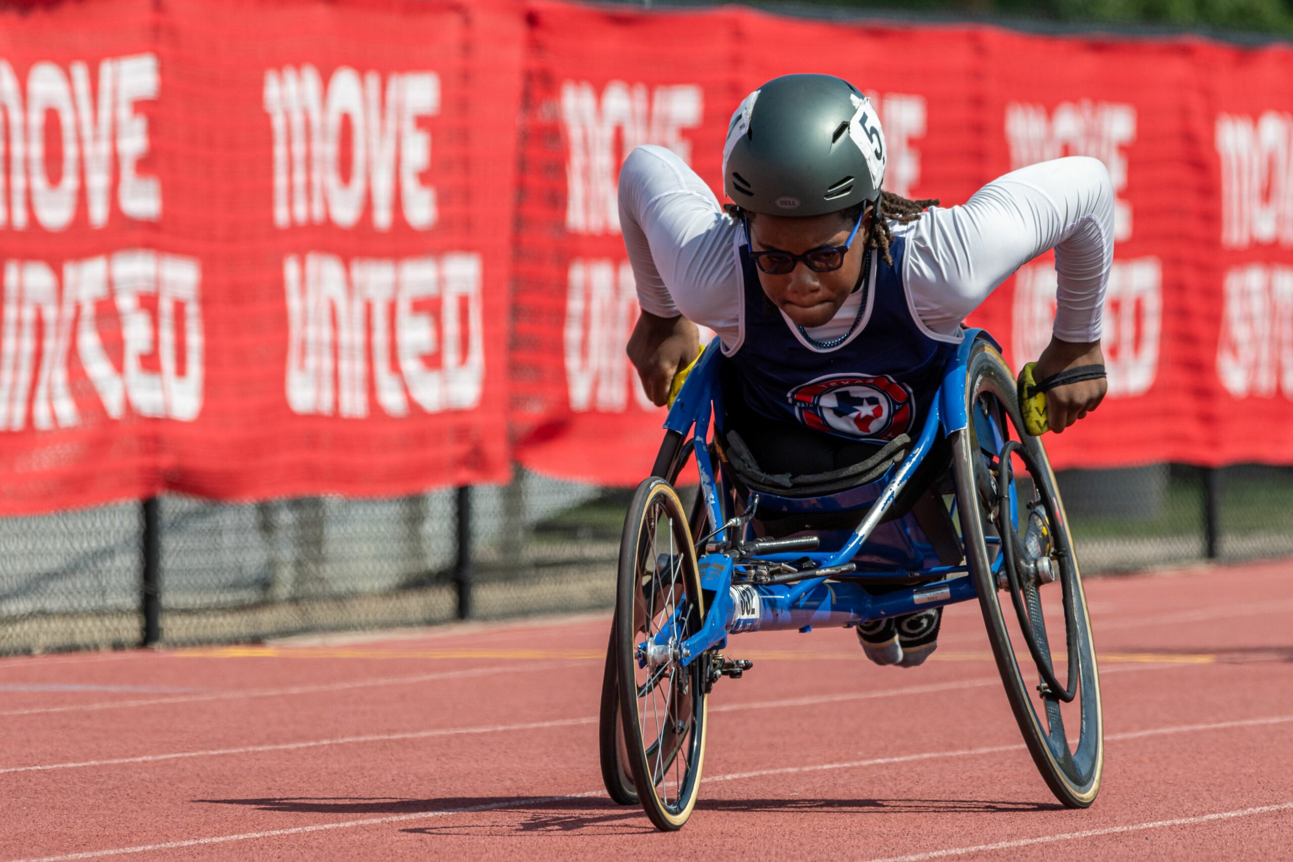 Adaptive athlete wheelchair racing on the track