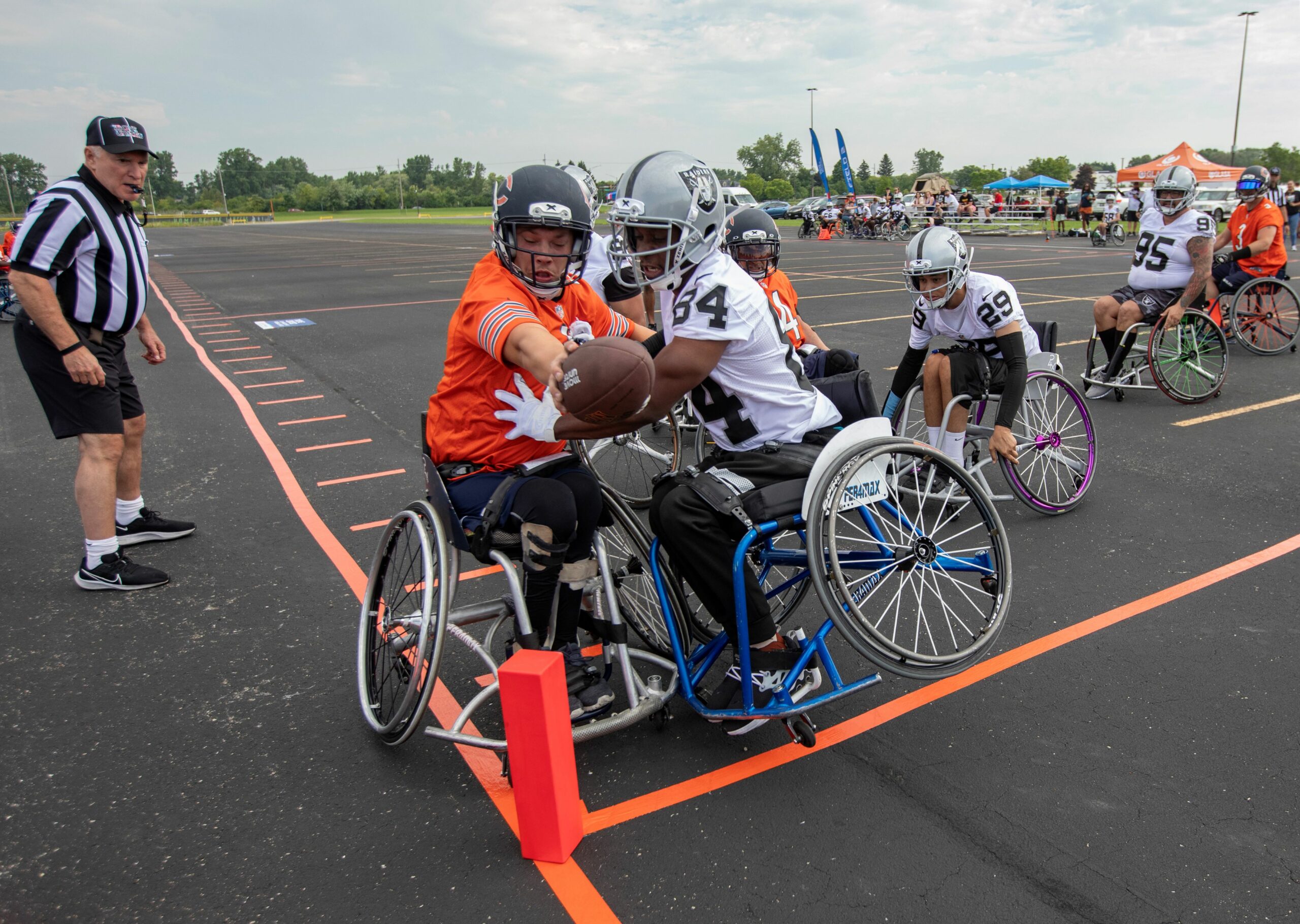 Gabe Denbraber of the GLASA Chicago Bears extends the ball toward the goal line against defender Darnell Calahan of the Las Vegas Raiders at the USA Wheelchair Football League Chicago Tournament.