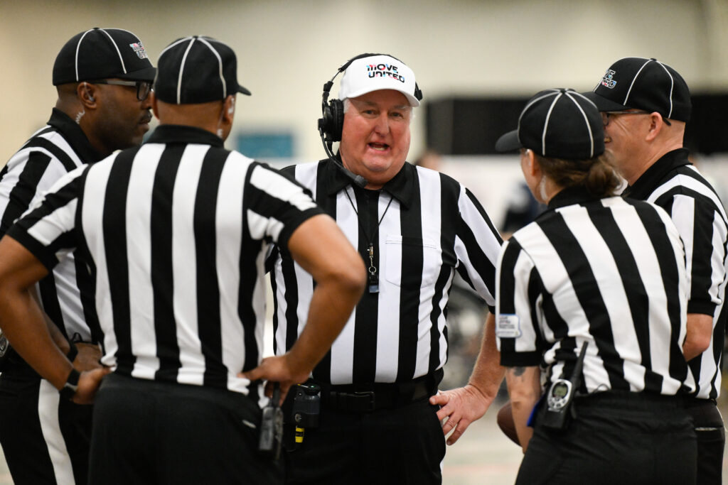 Image of Wheelchair Football Officials in Huddle