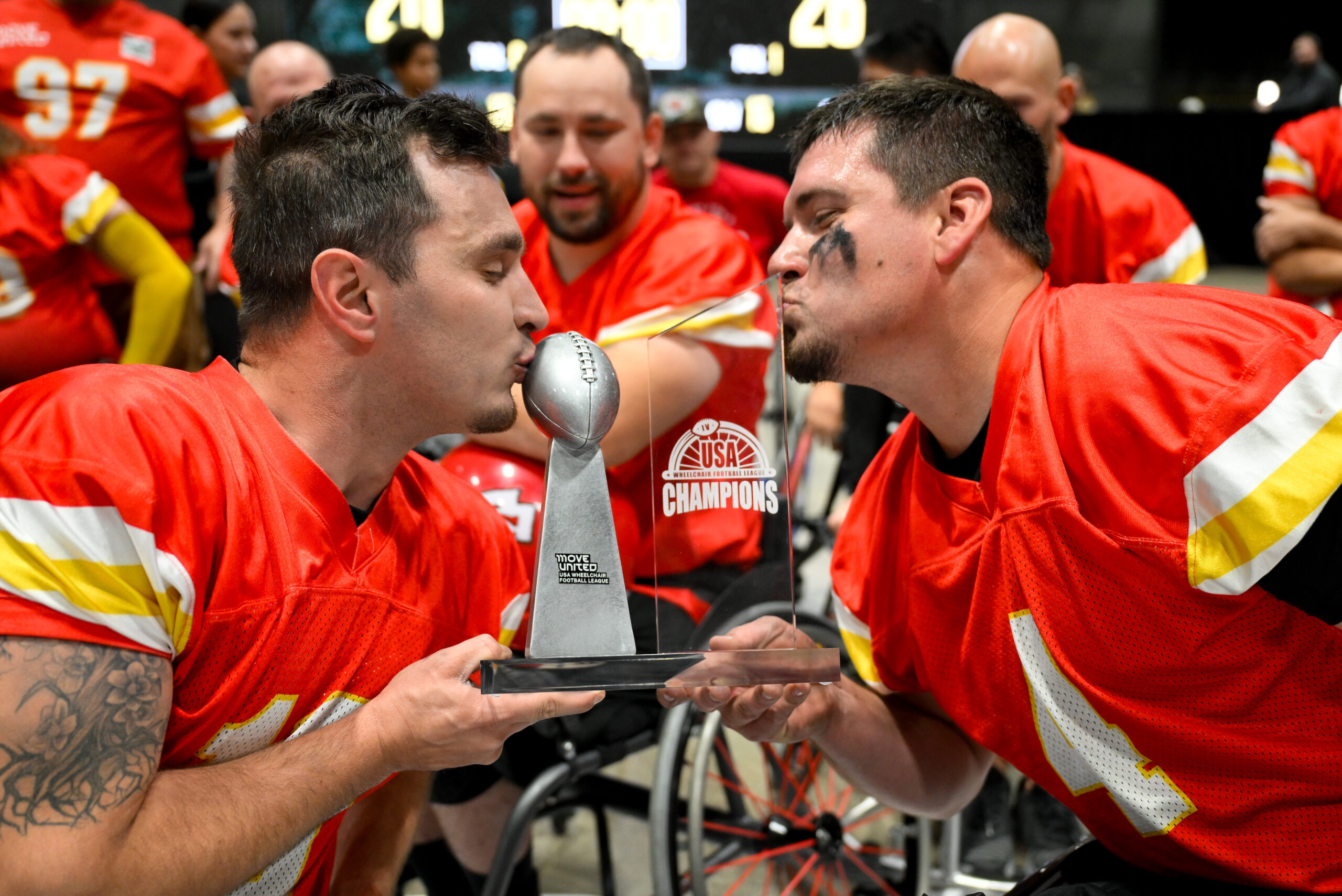 KC Wheelchair Football Team Kissing the USAWFL Championship IV Trophy