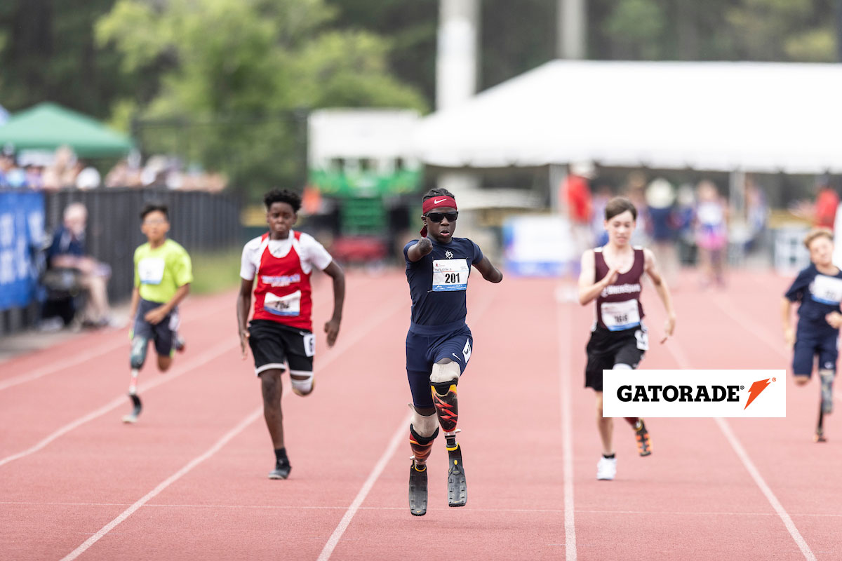 Youth athletes running down a track towards the camera with the Gatorade logo visible.