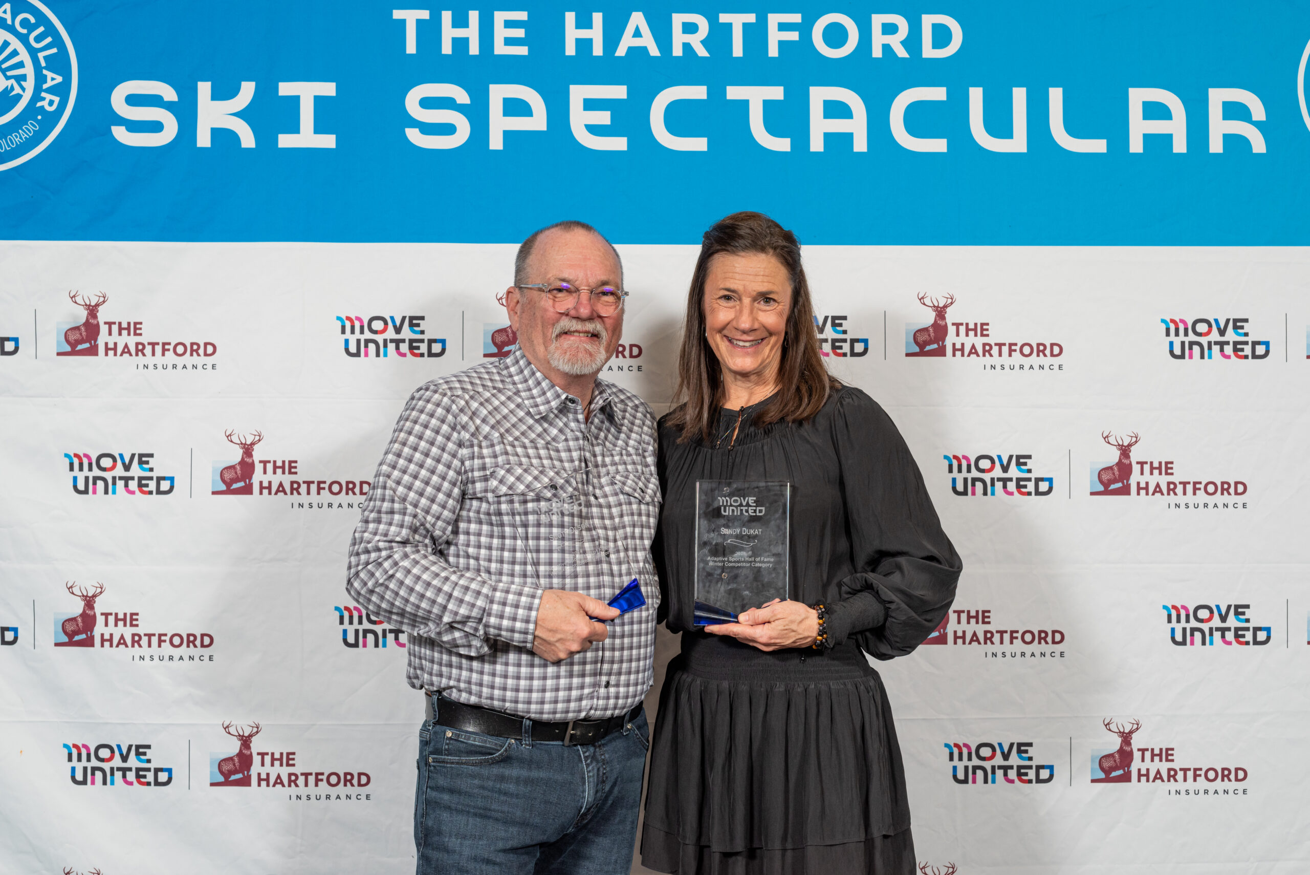 Scott Olson and Sandy Dukat posing with their awards