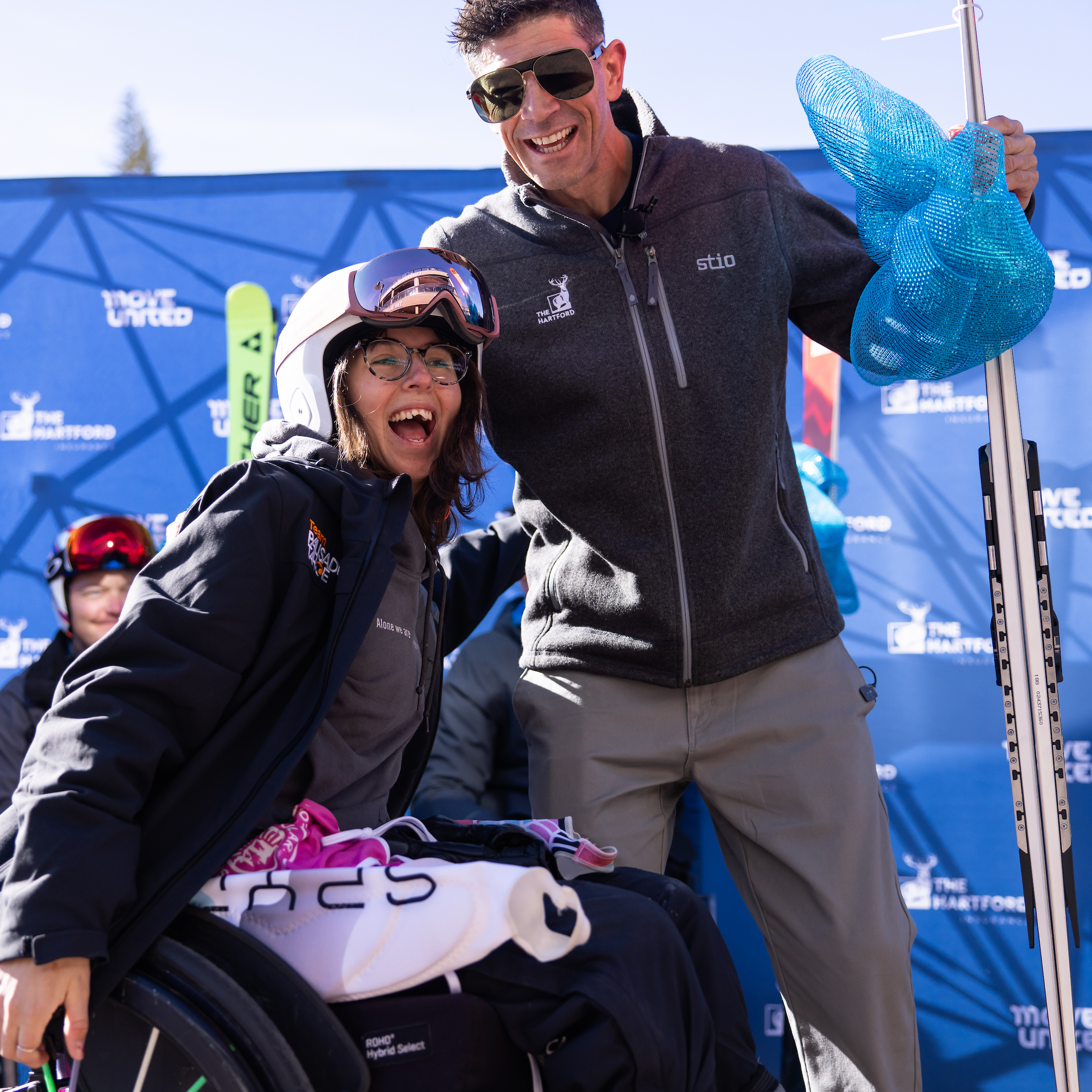 Girl in wheelchair hugging Paralympic Snowboarder Keith Gabel, exciting to be gifted skies