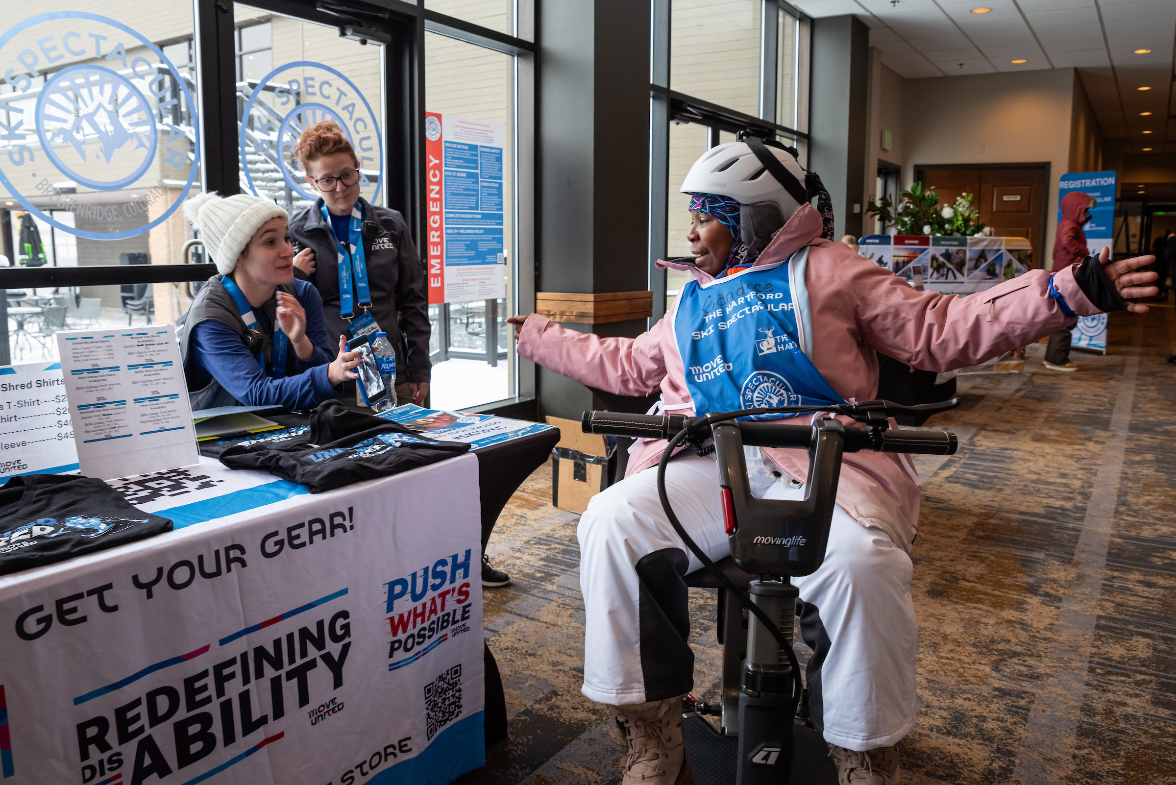 Ski Spec attendee talking to Move United Staff at a check in table
